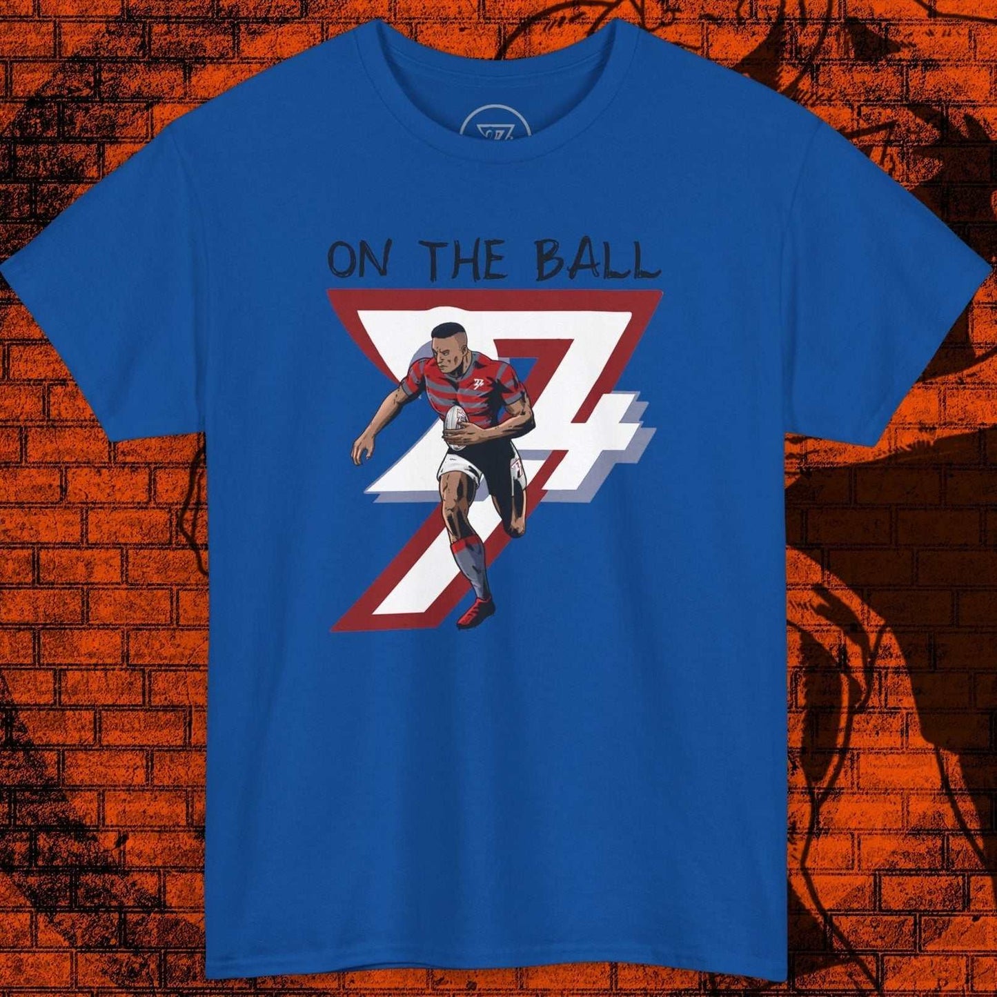 Blue rugby sports tee with hand-drawn rugby player illustration and "On The Ball" text on front