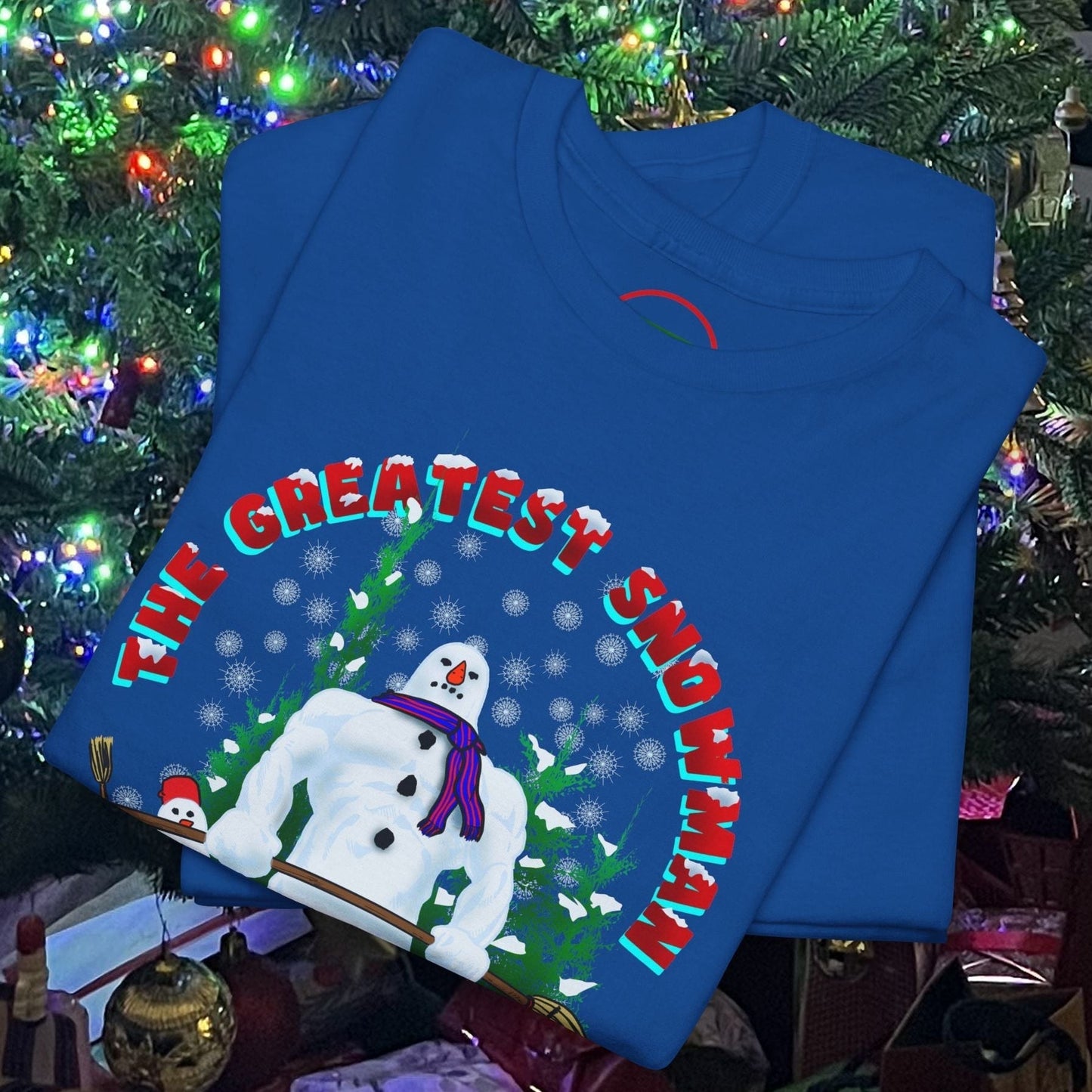 Blue snowman gym t-shirt with funny Christmas workout design folded under decorated Christmas tree lights