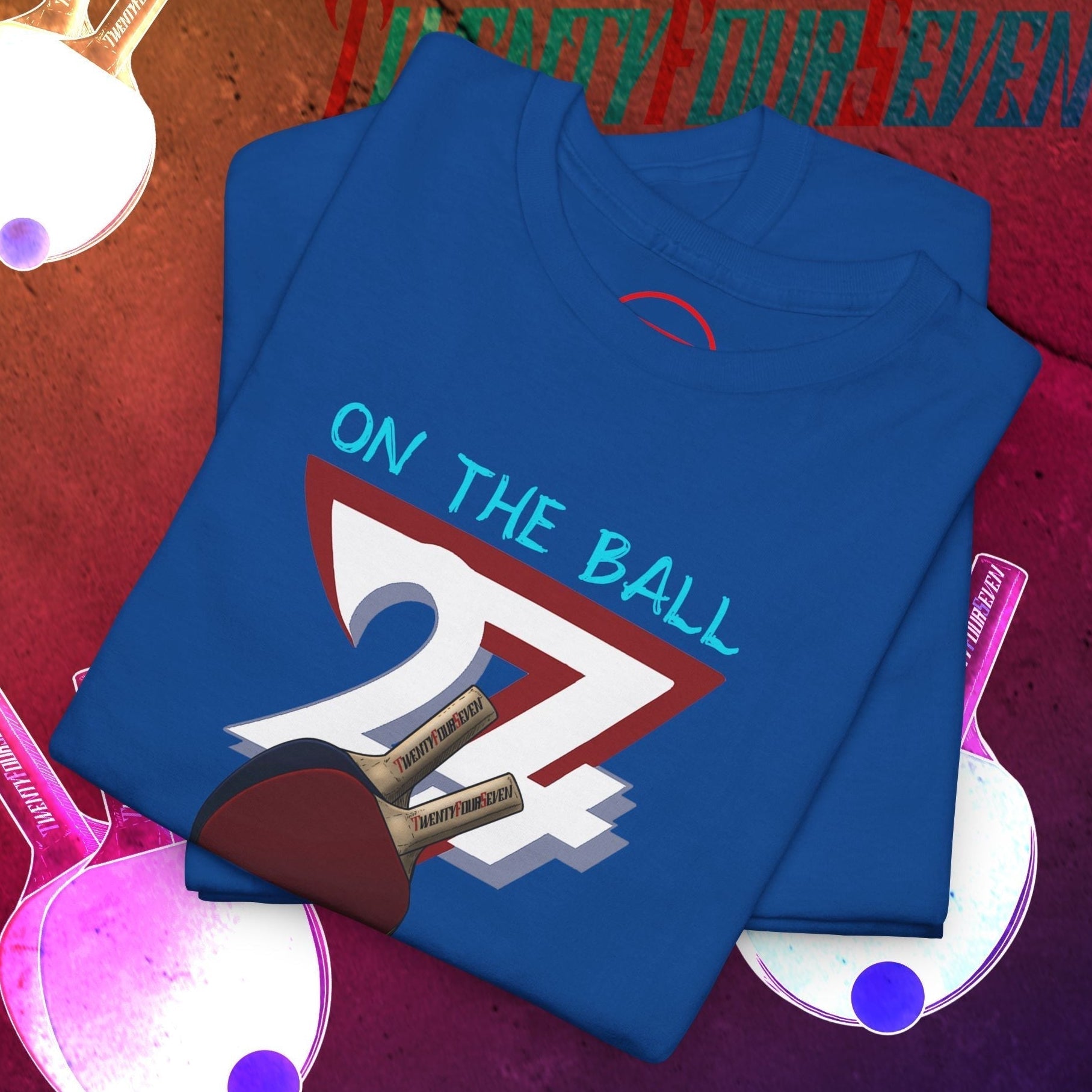 Blue table tennis t-shirt with hand-drawn ping pong paddle and ball graphic and "ON THE BALL" text
