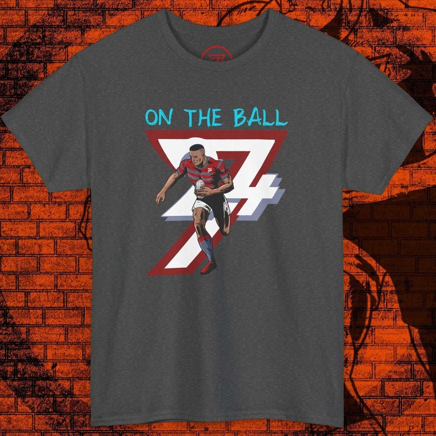 Comic-style rugby player graphic t-shirt with "On The Ball" text on dark fabric, sports fan gift tee