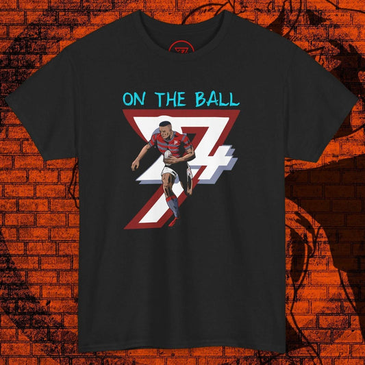 Comic-style rugby player running with ball graphic on black t-shirt with "On The Ball" text