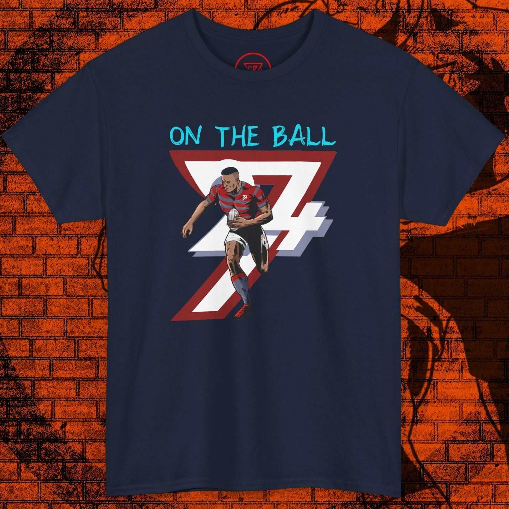 Comic-style rugby player t-shirt with dynamic hand-drawn graphic and "On The Ball" text on navy blue cotton tee