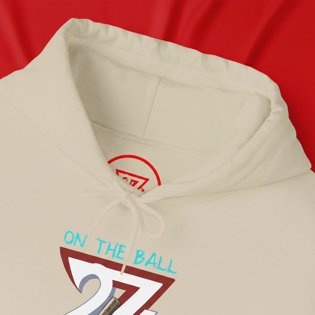 Cream ping pong hoodie with hand-drawn "On The Ball" design and adjustable drawstring hood