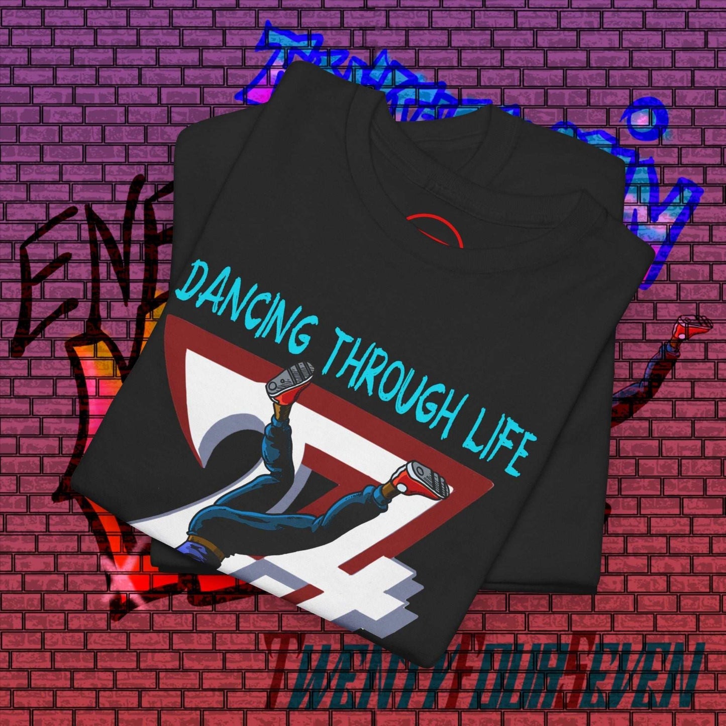 Dance Graphic T-Shirt with hand-drawn street dance illustration and "Dancing Through Life" text on black fabric.
