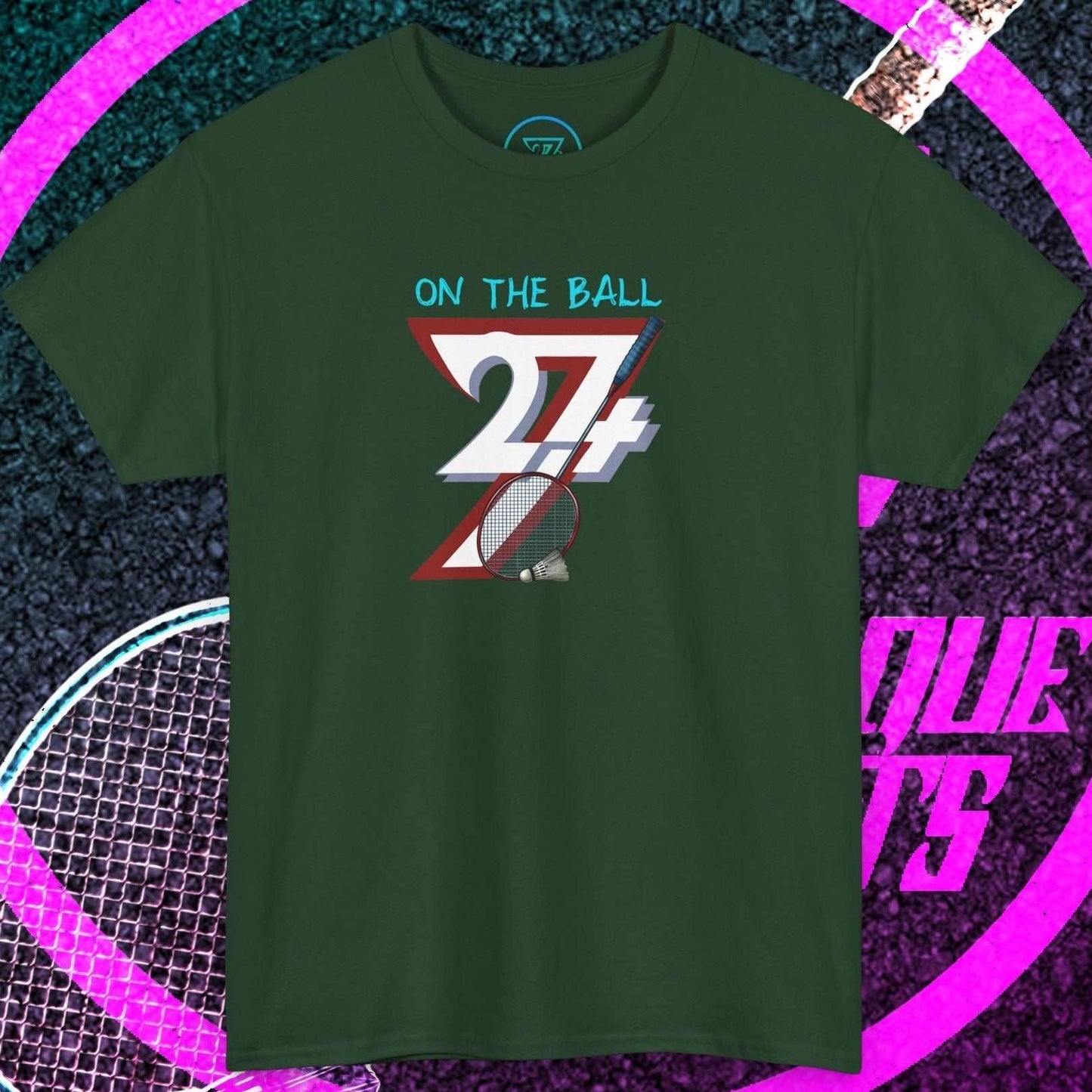 Dark green badminton hand-drawn graphic tee with "On The Ball" text and shuttlecock illustration, casual sportswear for outdoor play