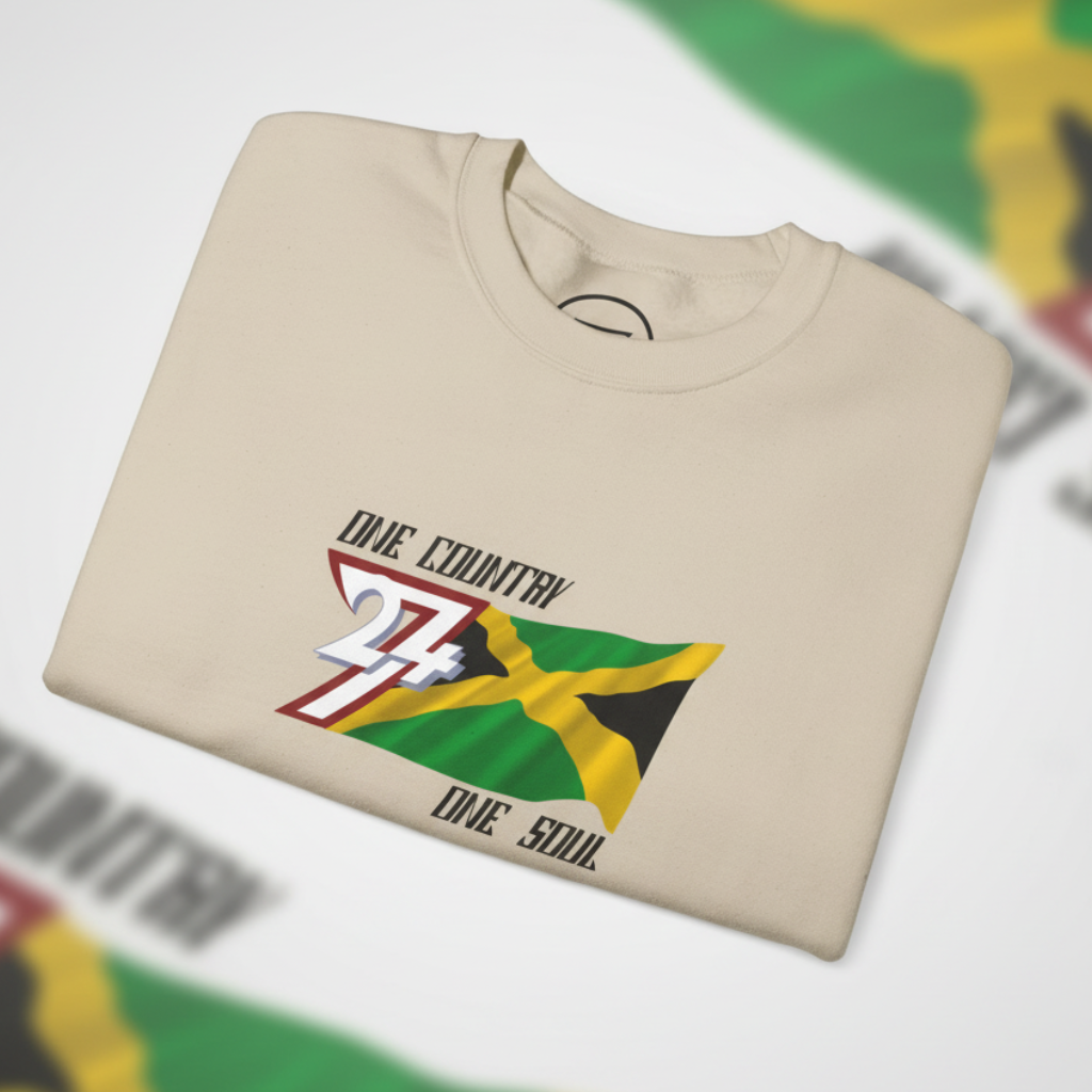 Folded beige Jamaica Flag Crewneck Sweatshirt with "One Country One Soul" text and vibrant hand-drawn Jamaican flag design on the chest