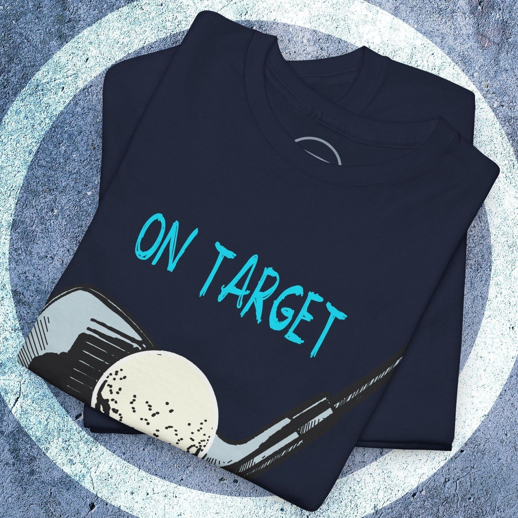 Folded dark golf tee illustrated t-shirt with vibrant hand-drawn golf club and ball graphic and "ON TARGET" text