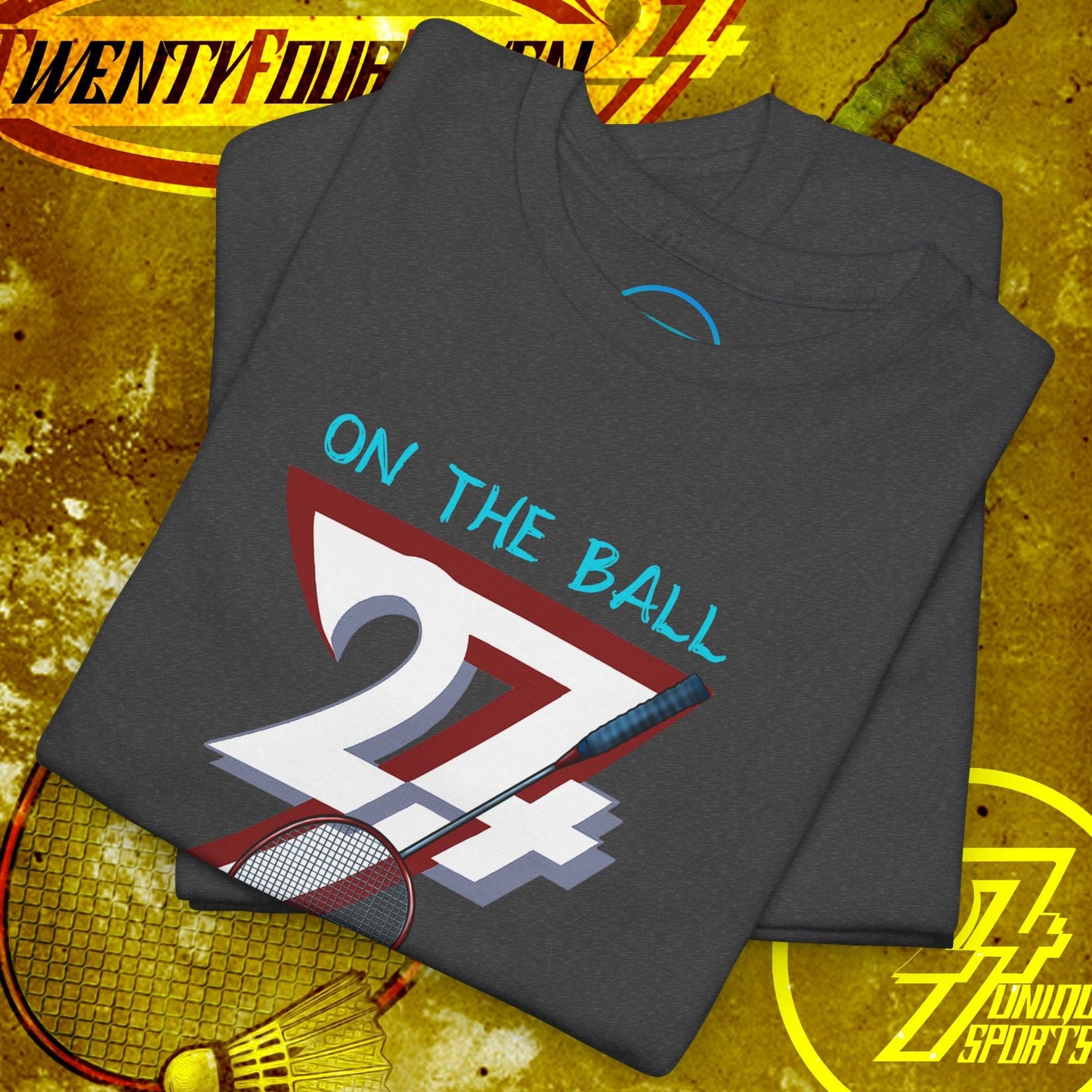 Folded dark gray badminton tee with hand-drawn style graphic of "24/7" and shuttlecock, designed for outdoor sports fans