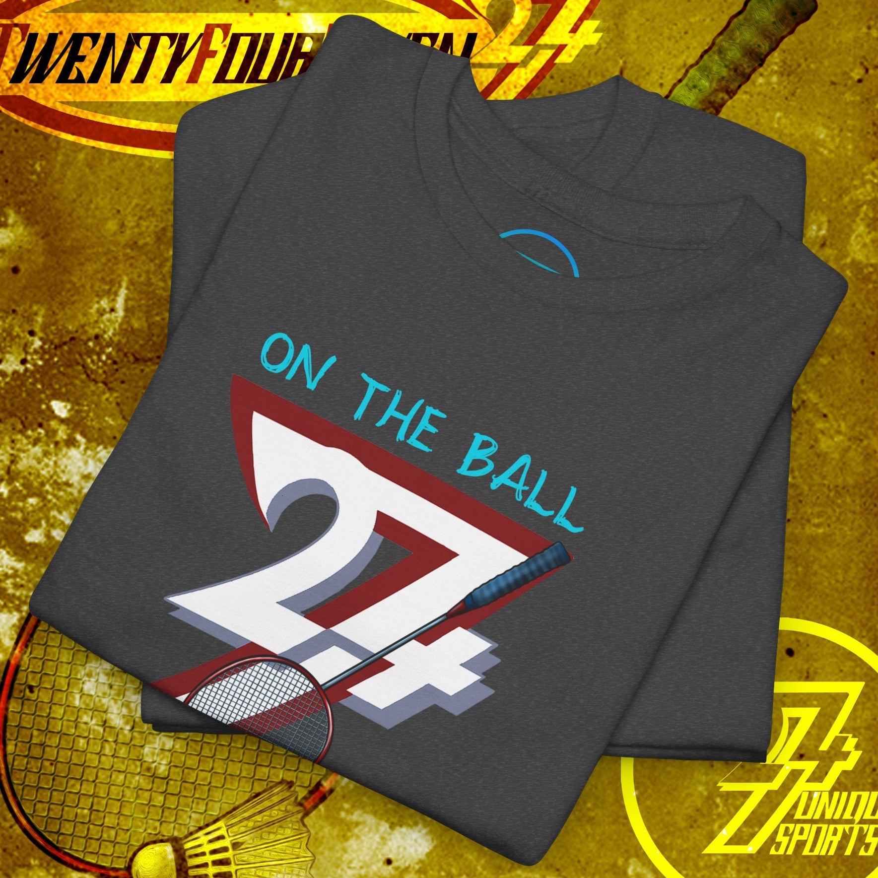 Folded dark gray badminton tee with hand-drawn style graphic of "24/7" and shuttlecock, designed for outdoor sports fans
