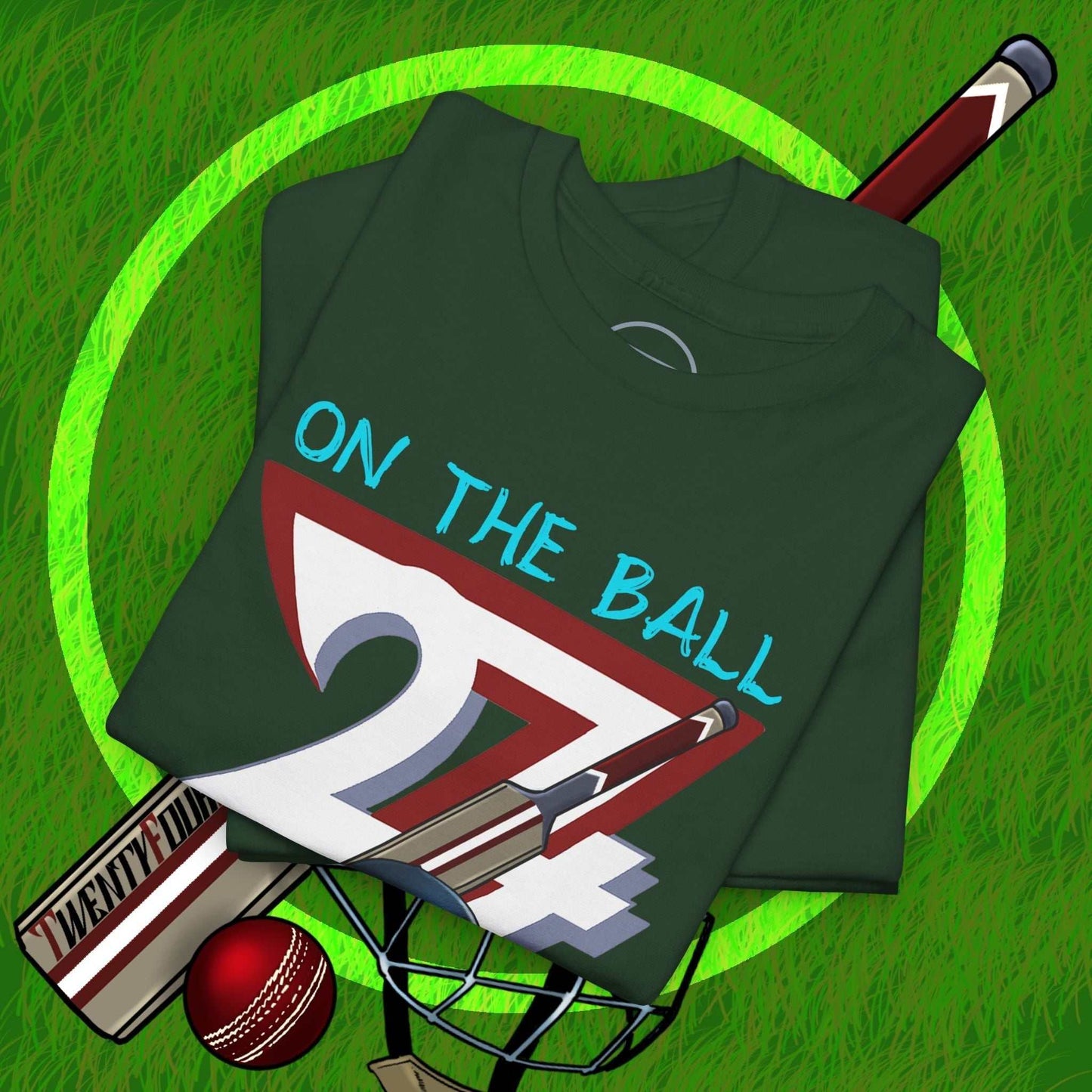 Folded dark green hand-drawn cricket tee with "On The Ball 24/7" graphic, cricket bat, ball, and helmet on grass background