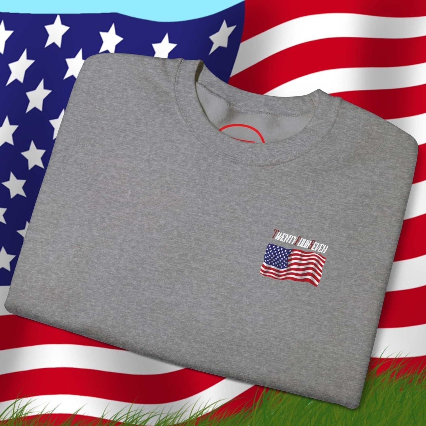 Folded gray US Flag Sweatshirt with small American flag design on front, displayed over a large waving US flag background