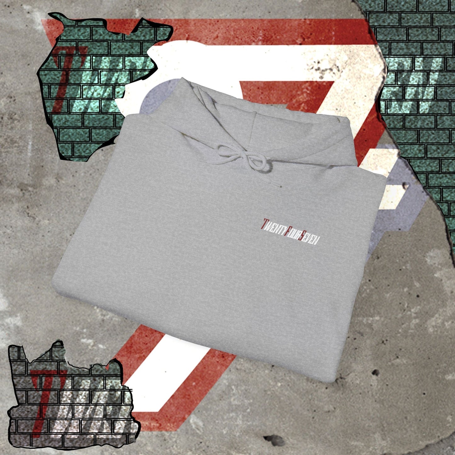 Folded grey printed hoodie with twentyfourseven logo on concrete floor with graphic background