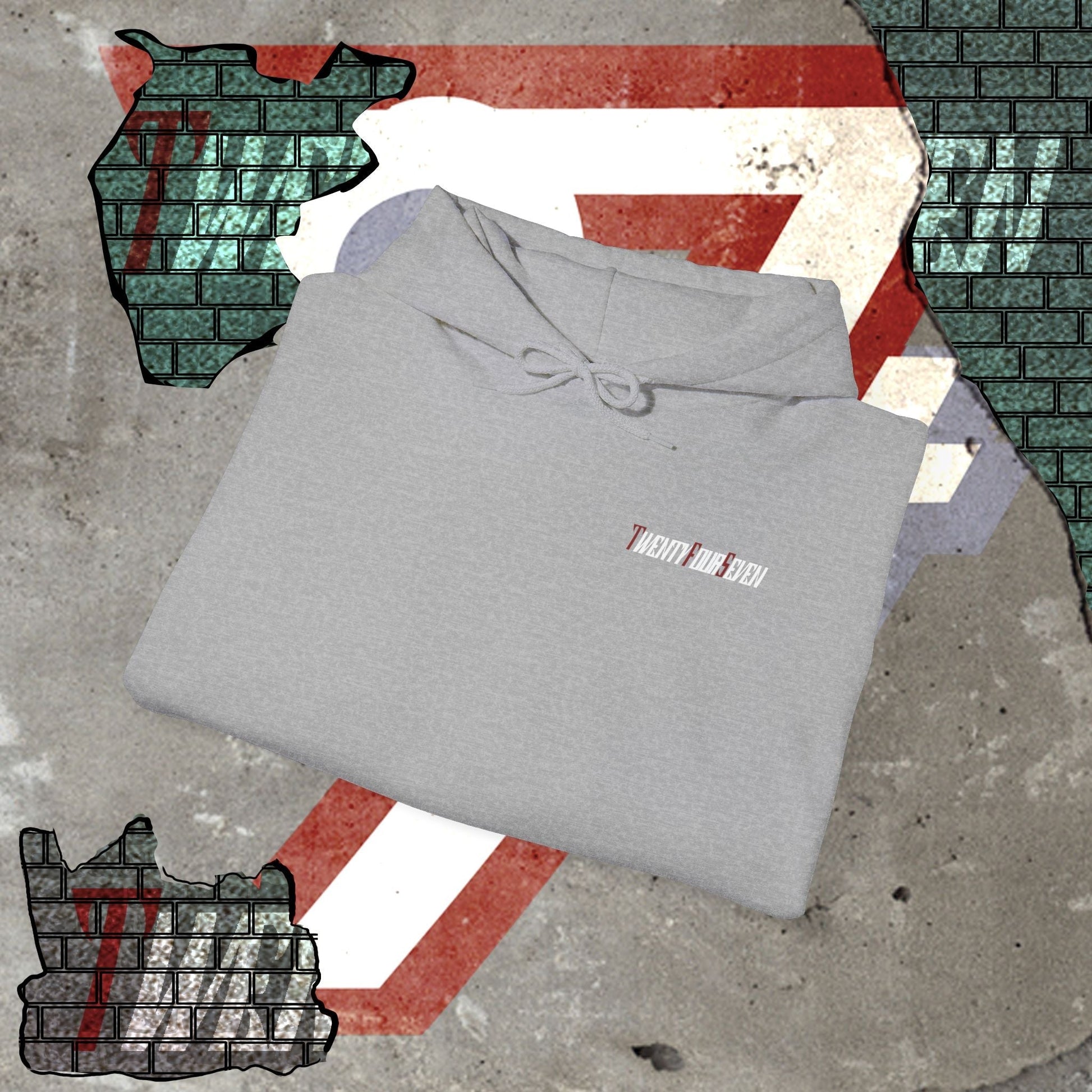 Folded grey printed hoodie with twentyfourseven logo on concrete floor with graphic background