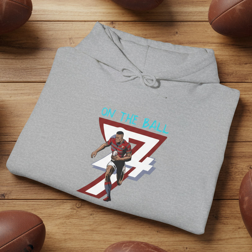 Folded grey rugby hoodie with vibrant hand-drawn rugby player and number 7 design