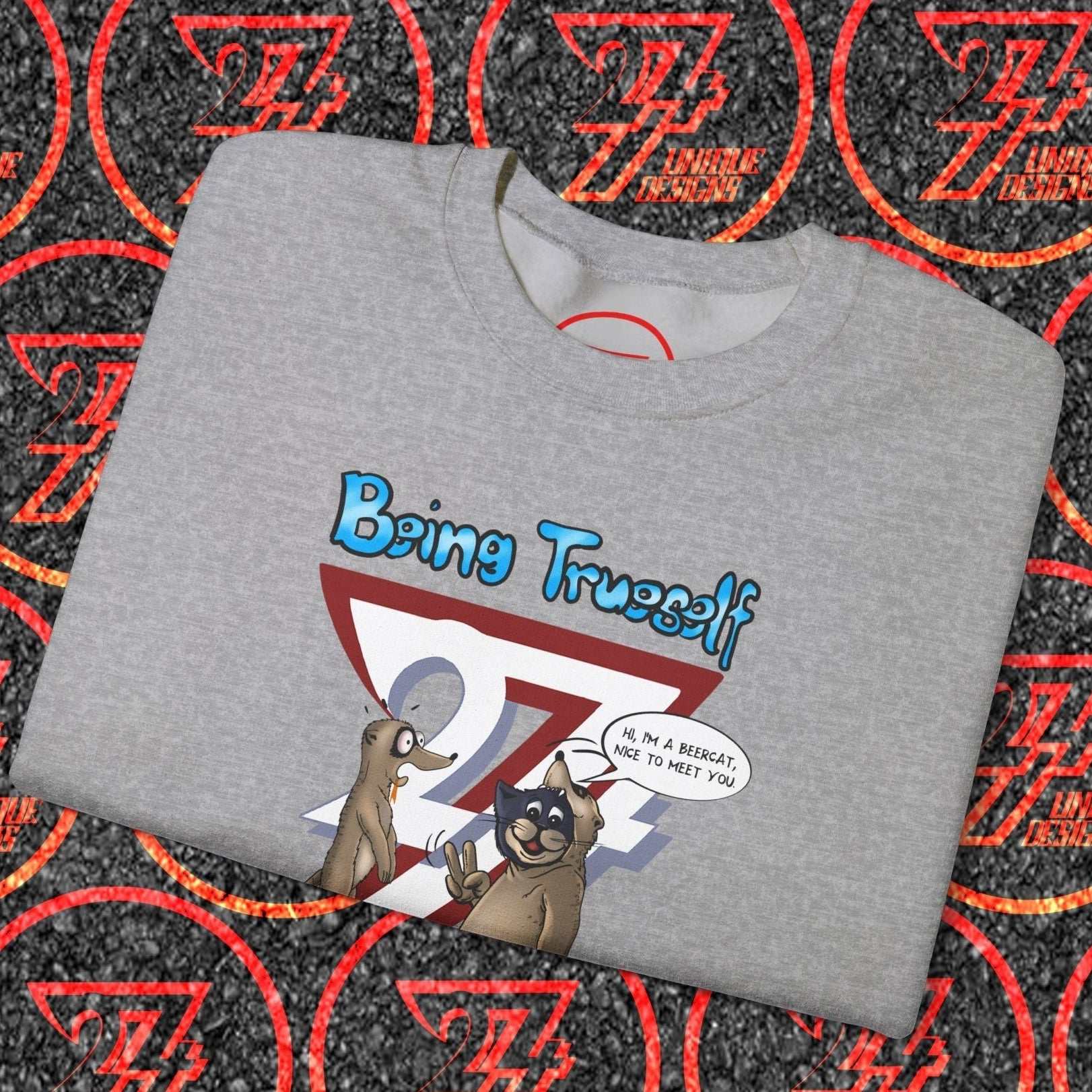 Folded grey unisex sweatshirt with cartoon cat and meerkat saying "Being True to Yourself" slogan design