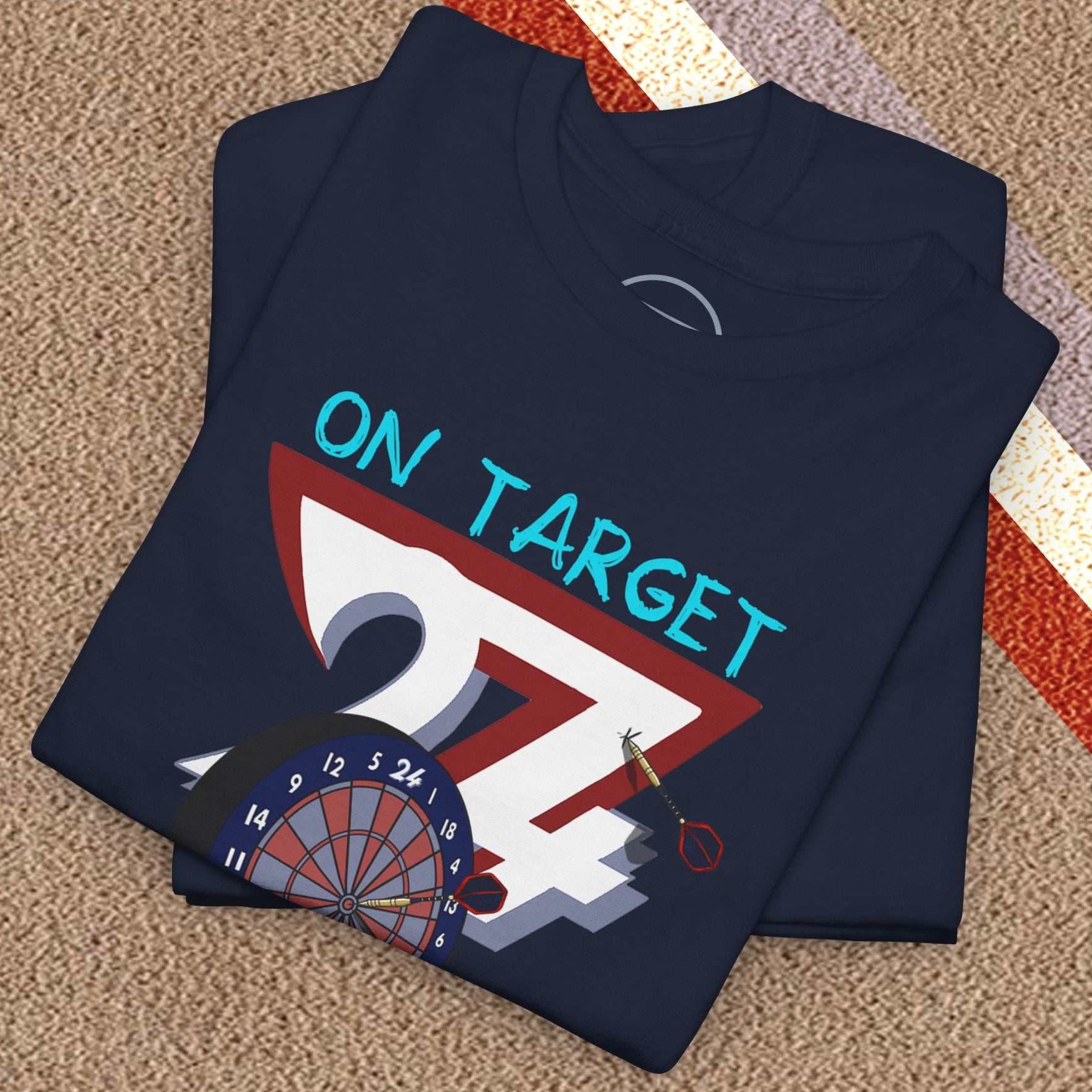 Folded navy darts t-shirt with "On Target 24/7" graphic and dartboard design