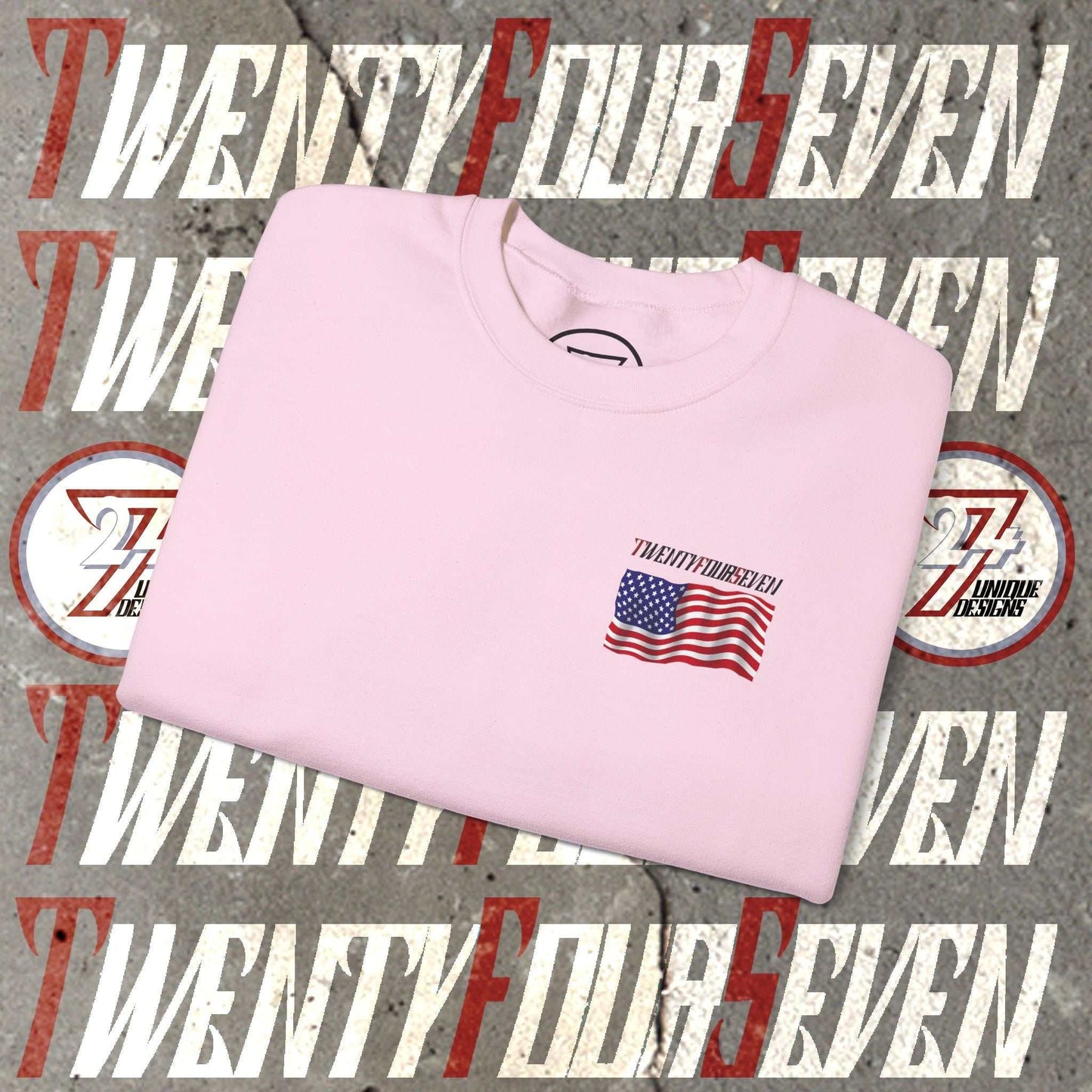 Folded pink sweatshirt with small hand-drawn American flag and "Twenty Four Seven" text design on front against a graphic background