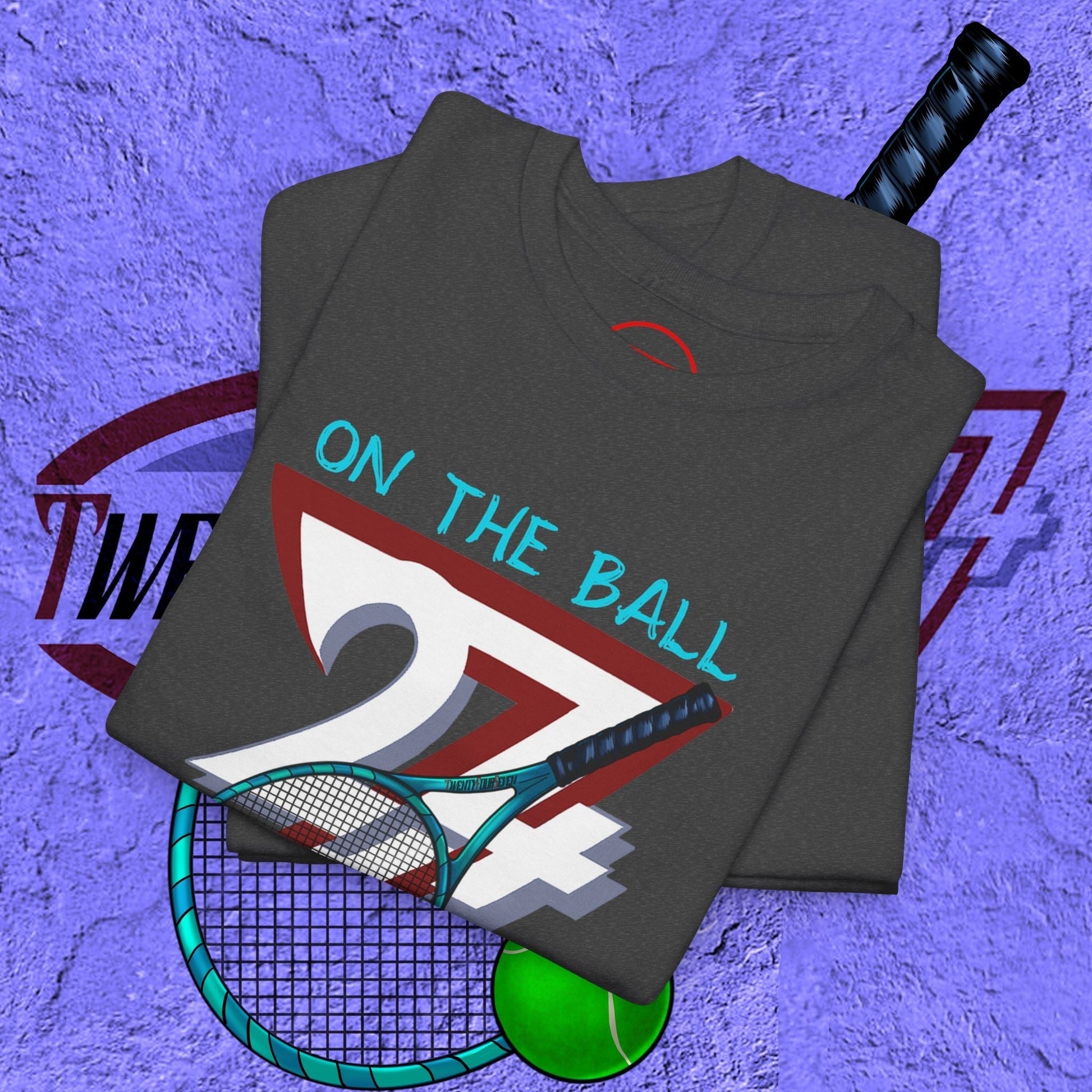 Folded tennis sport T-shirt with hand-drawn racket and ball design and text "On The Ball"