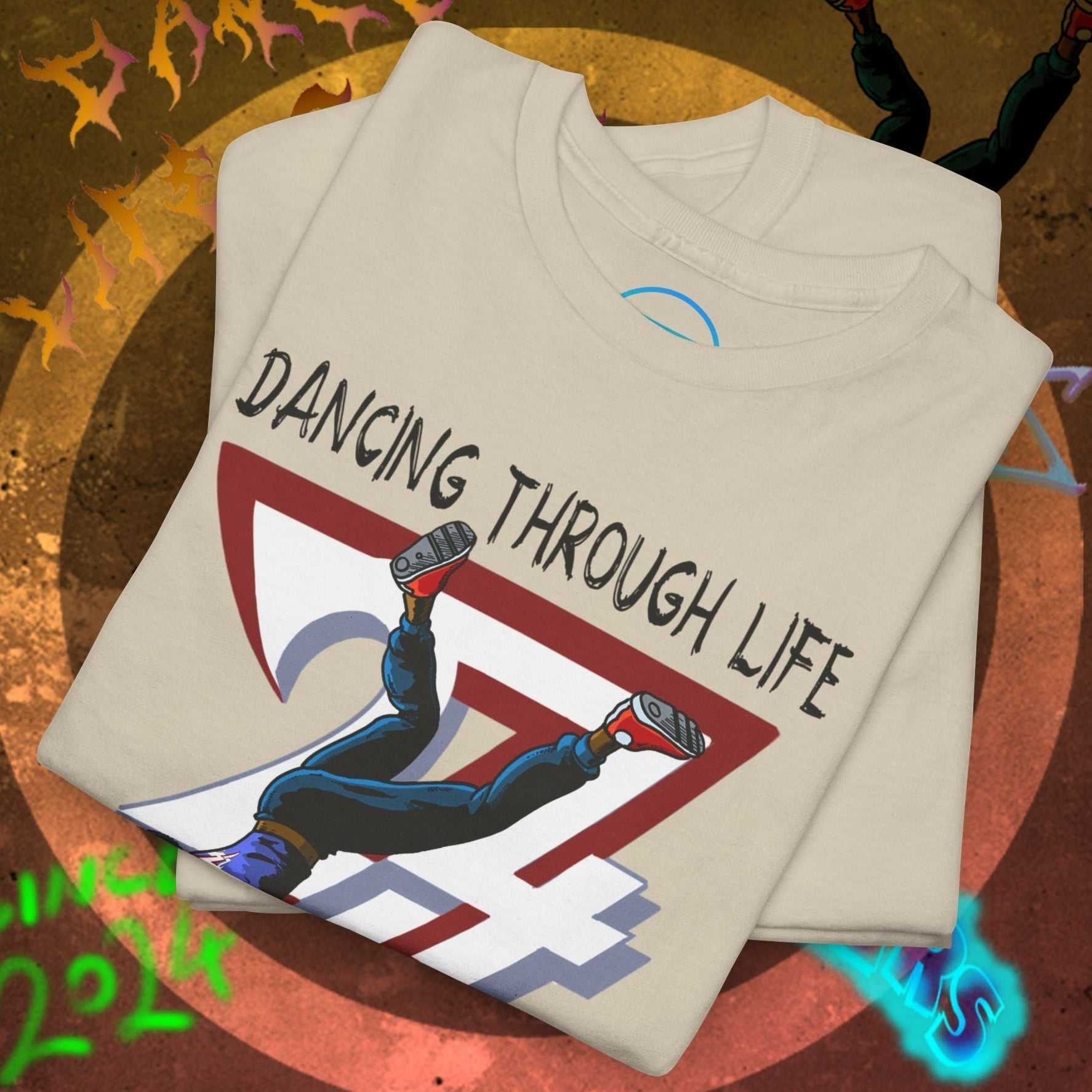 Folded white dance tee with comic-style hip-hop dancer graphic and "Dancing Through Life" text on front