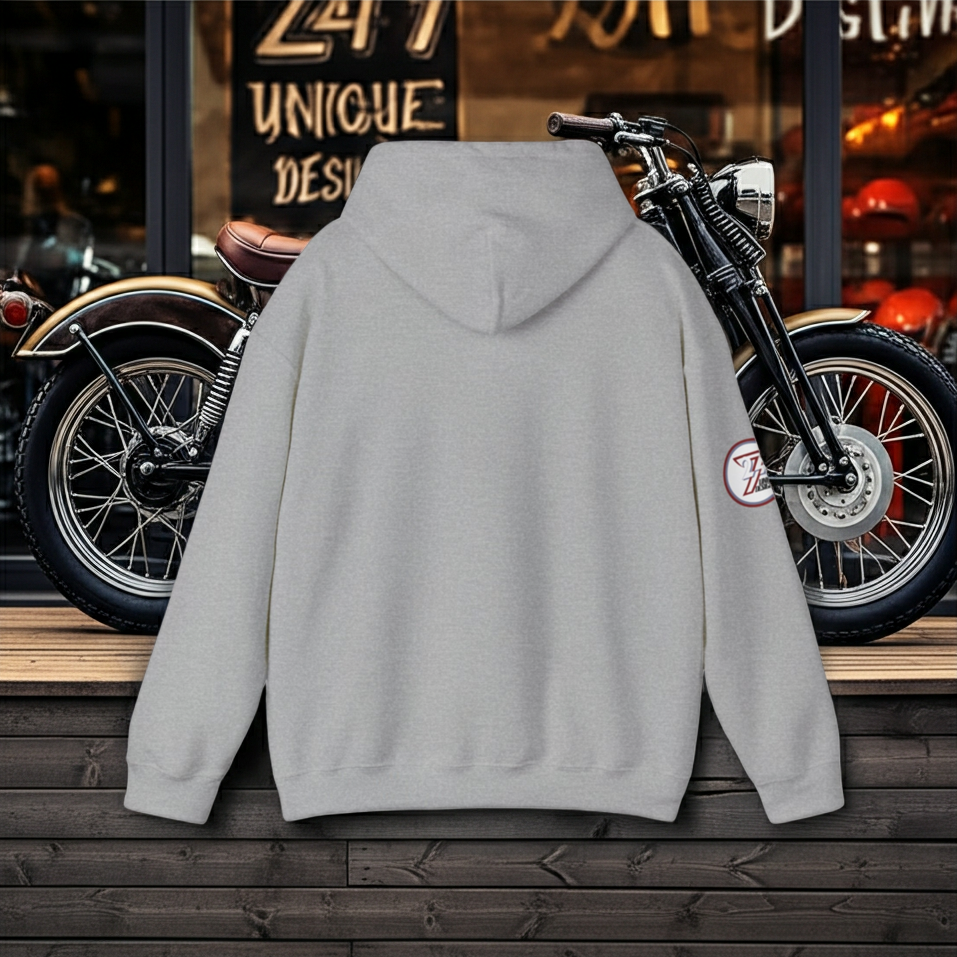 Gray bike hoodie with vintage bike design, displayed in front of classic motorcycle backdrop