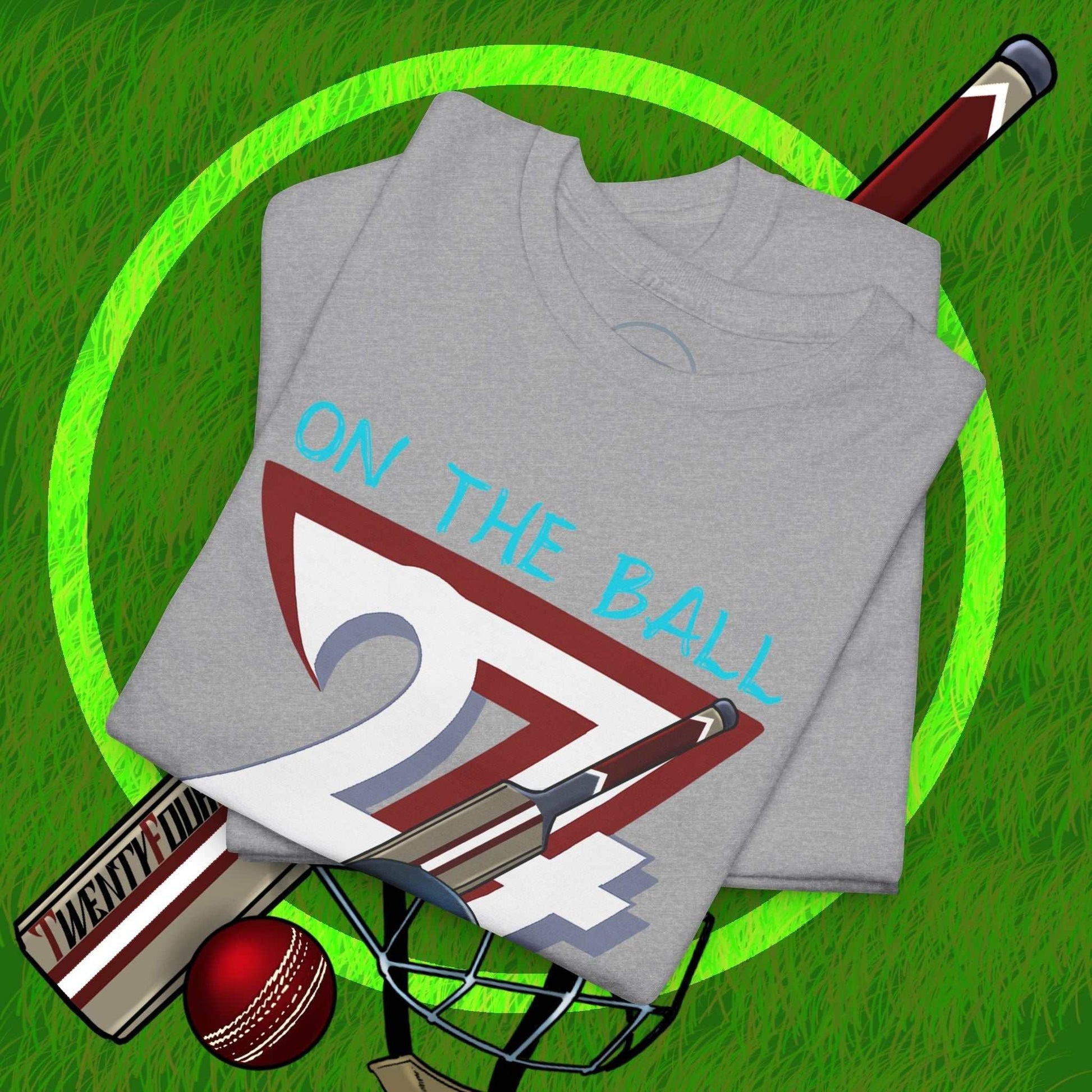 Gray hand-drawn cricket tee with vintage sports illustration and "On The Ball 24/7" text on grass background