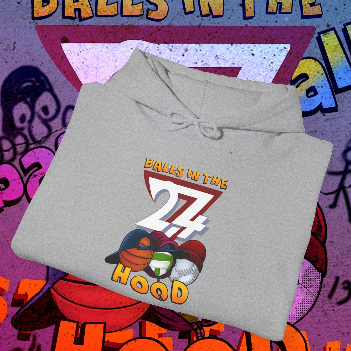 Gray printed hoodie with "Balls in the 27 Hood" design featuring sports balls, styled for urban streetwear and ballgames.