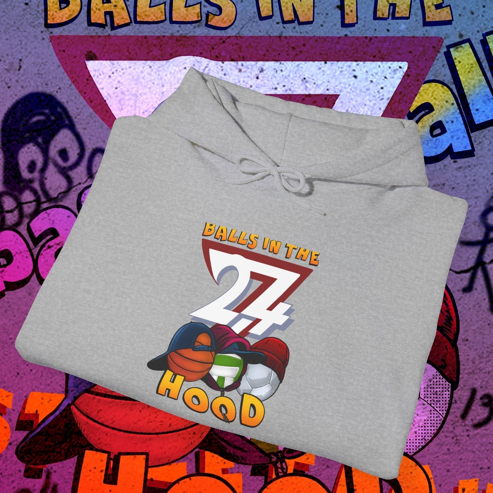 Gray printed hoodie with "Balls in the 27 Hood" design featuring sports balls, styled for urban streetwear and ballgames.