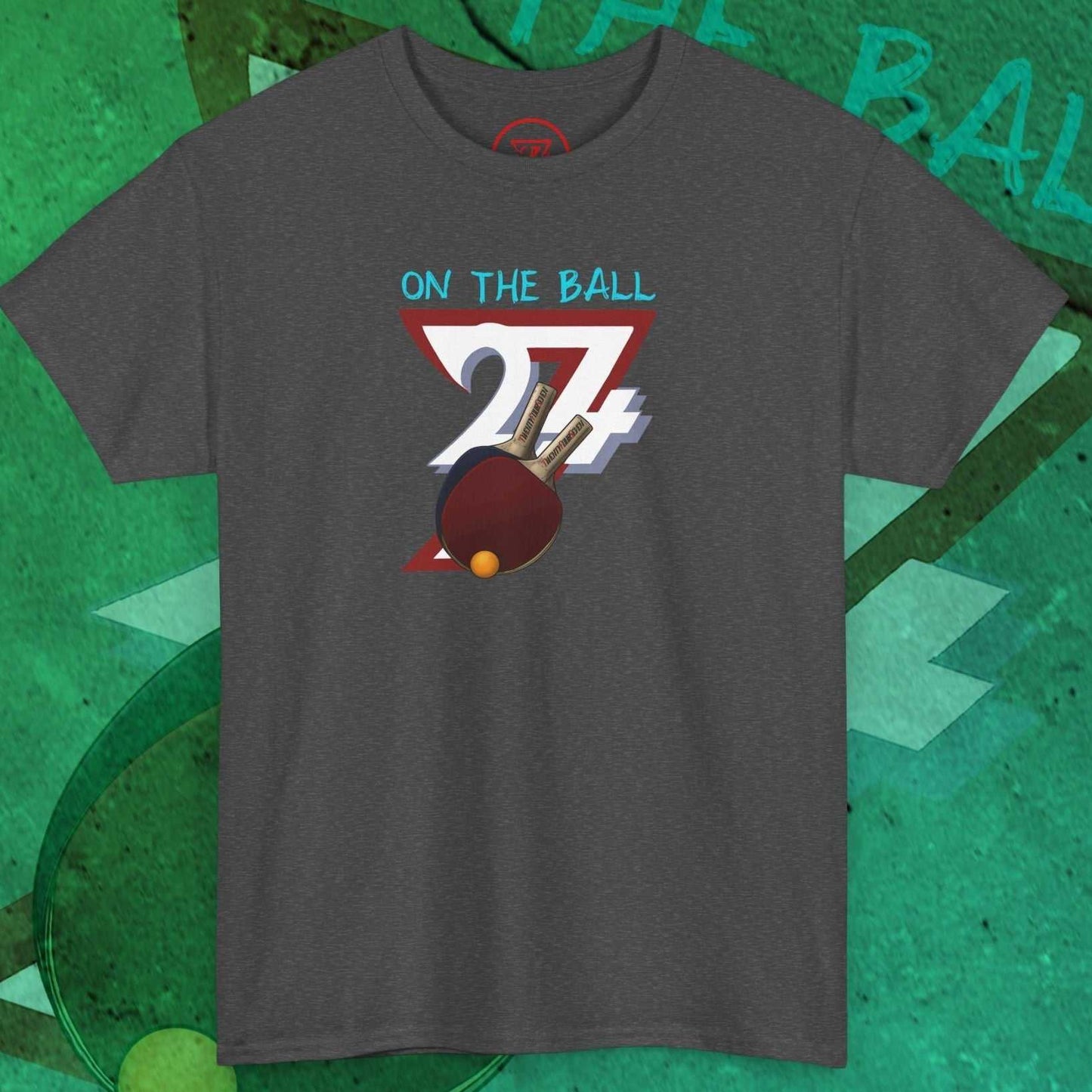 Gray table tennis t-shirt with hand-drawn ping pong paddle and ball graphic and "On The Ball 24/7" text design