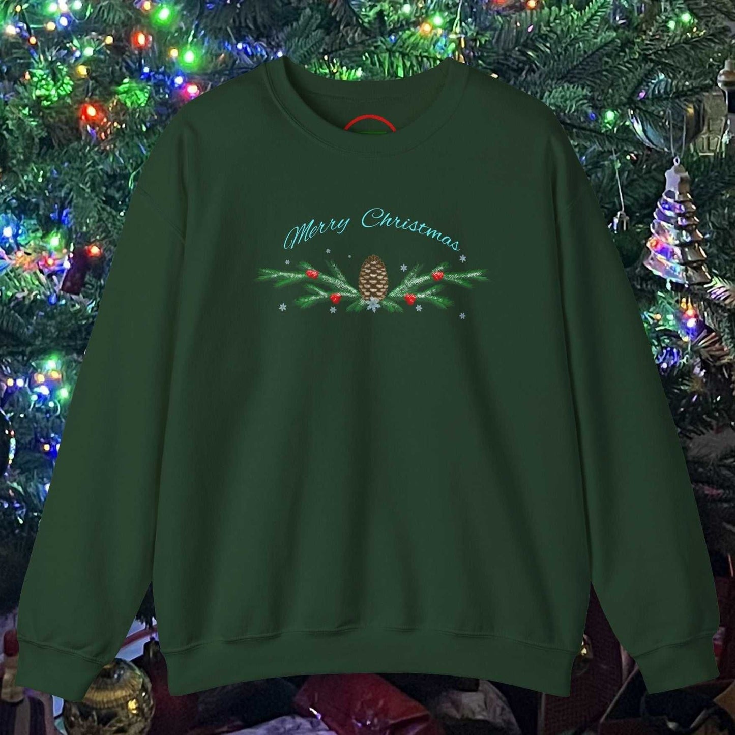 Green Pinecone Christmas sweatshirt with festive holiday design hanging in front of a decorated Christmas tree
