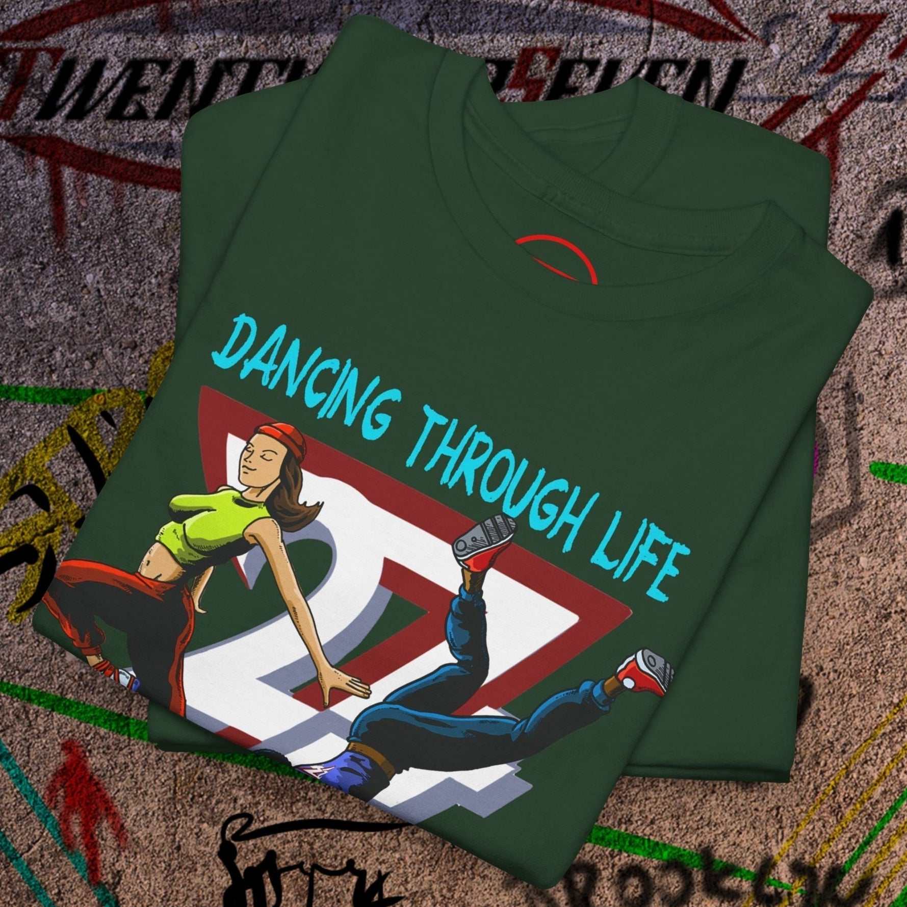 Green dance t-shirt with comic-style dancers and "Dancing Through Life" text, 90s streetwear vibe