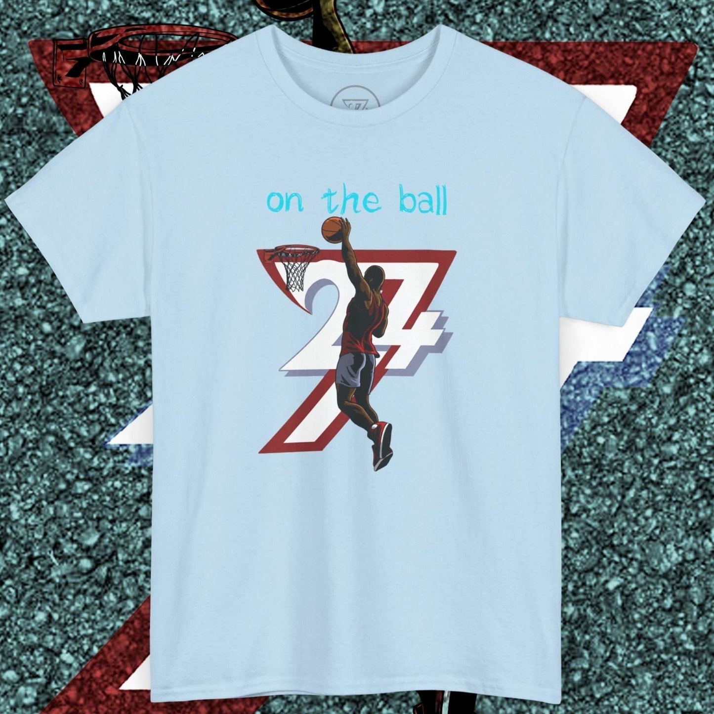 Light blue 90s comic-style basketball tee with hand-drawn player dunking ball and "on the ball" text