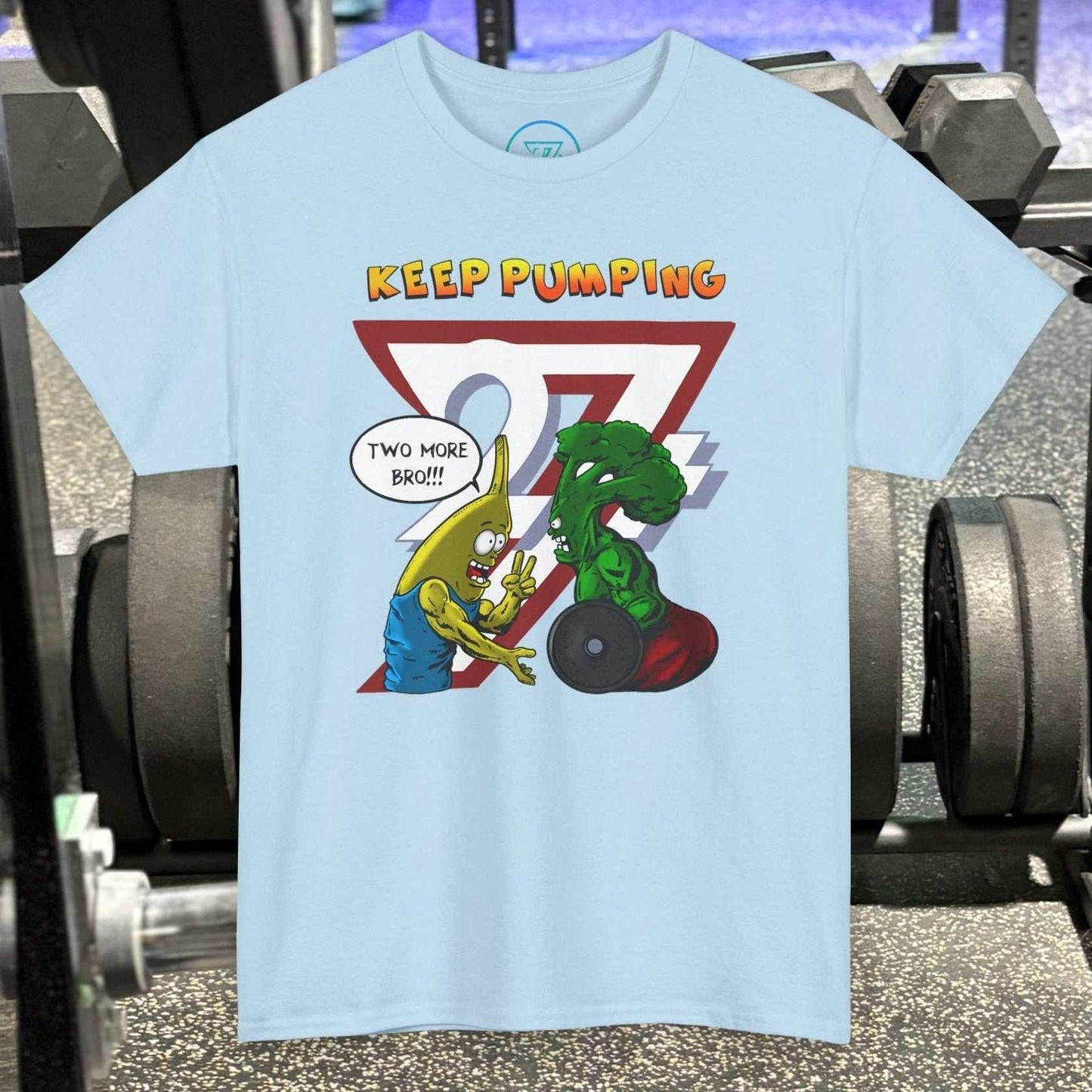 Light blue broccoli gym tee with cartoon banana and broccoli lifting weights and "Keep Pumping" text on chest