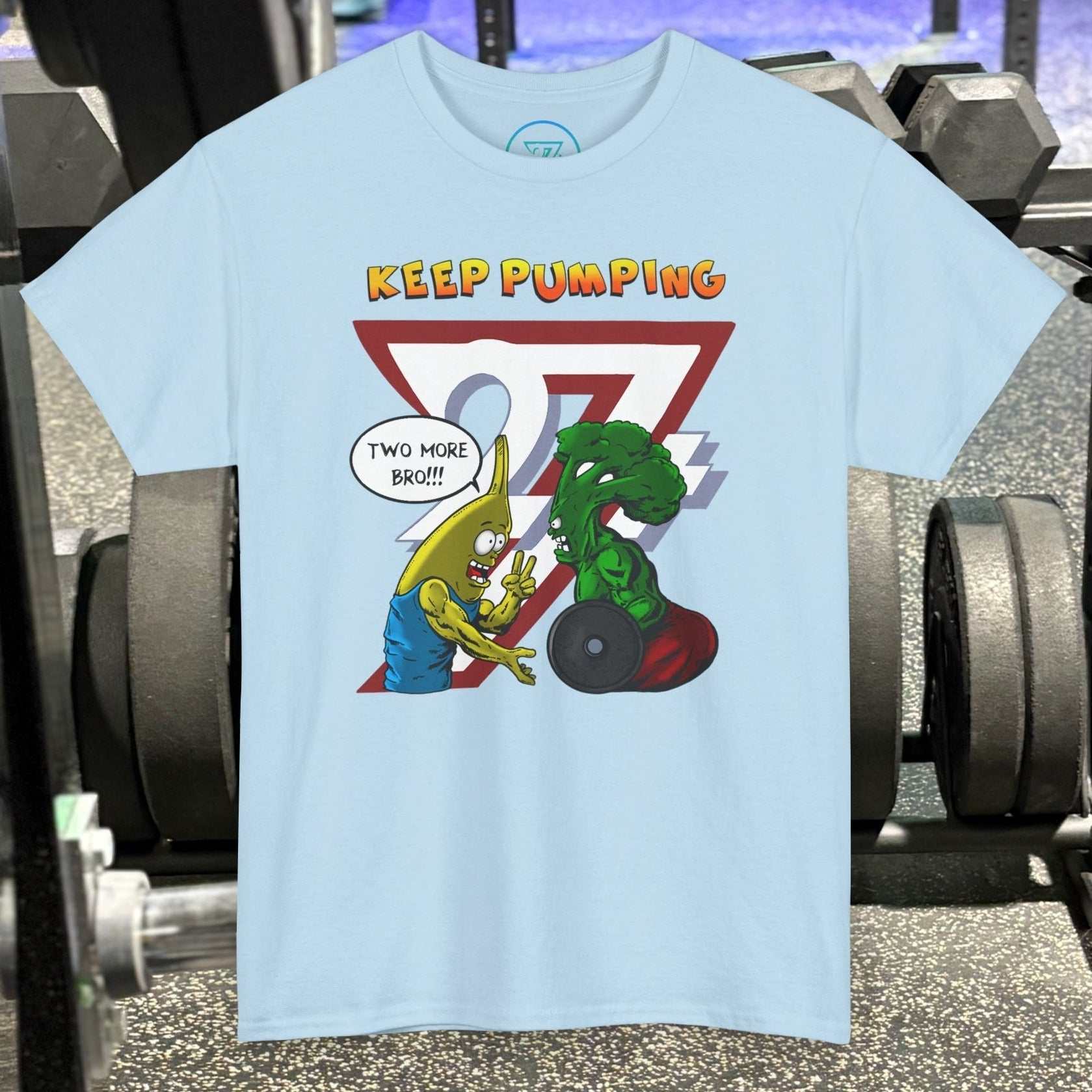 Light blue broccoli gym tee with cartoon banana and broccoli lifting weights and "Keep Pumping" text on chest