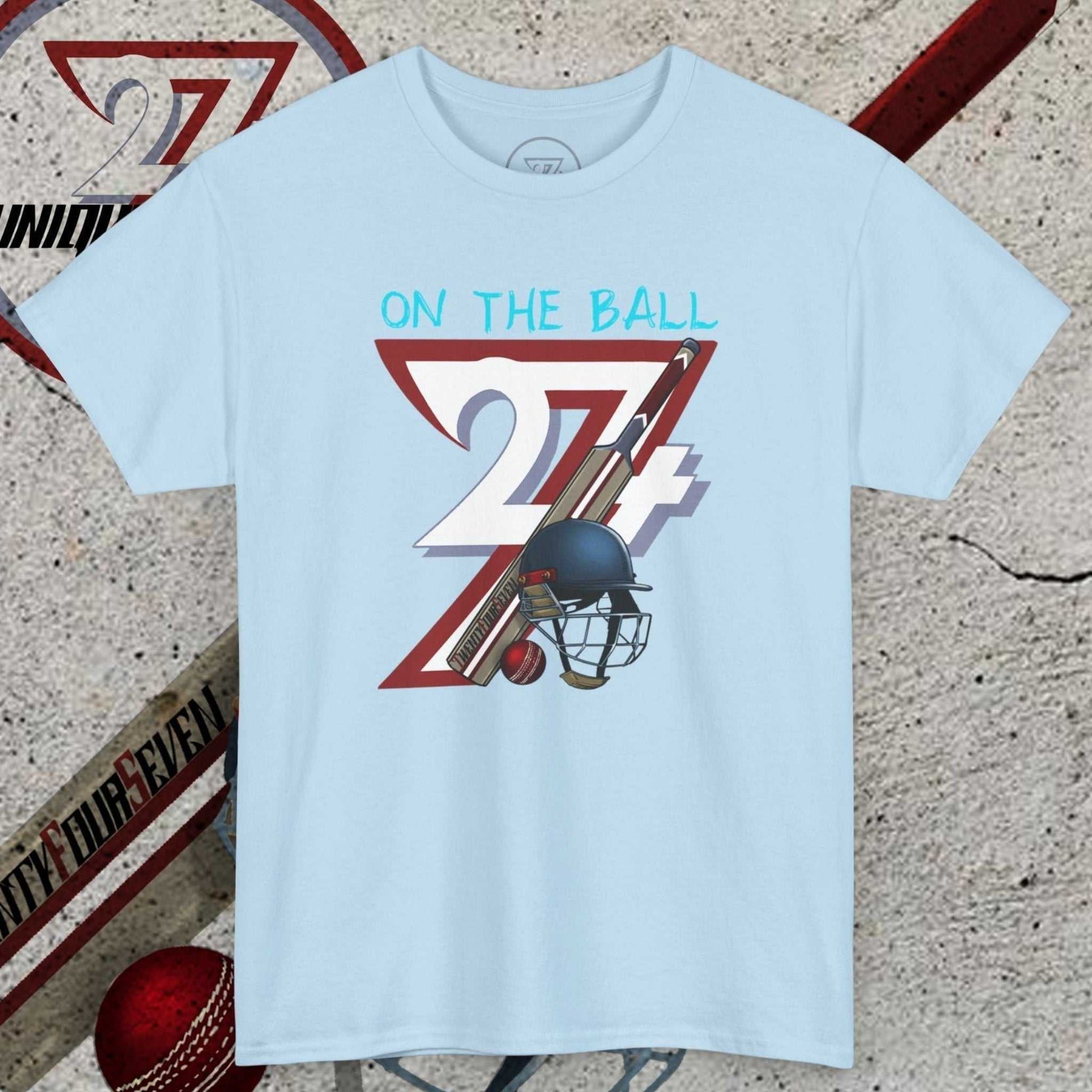 Light blue cricket tee with hand-drawn vintage 90s cricket illustration featuring bats, ball, and helmet, casual sports t-shirt for fans