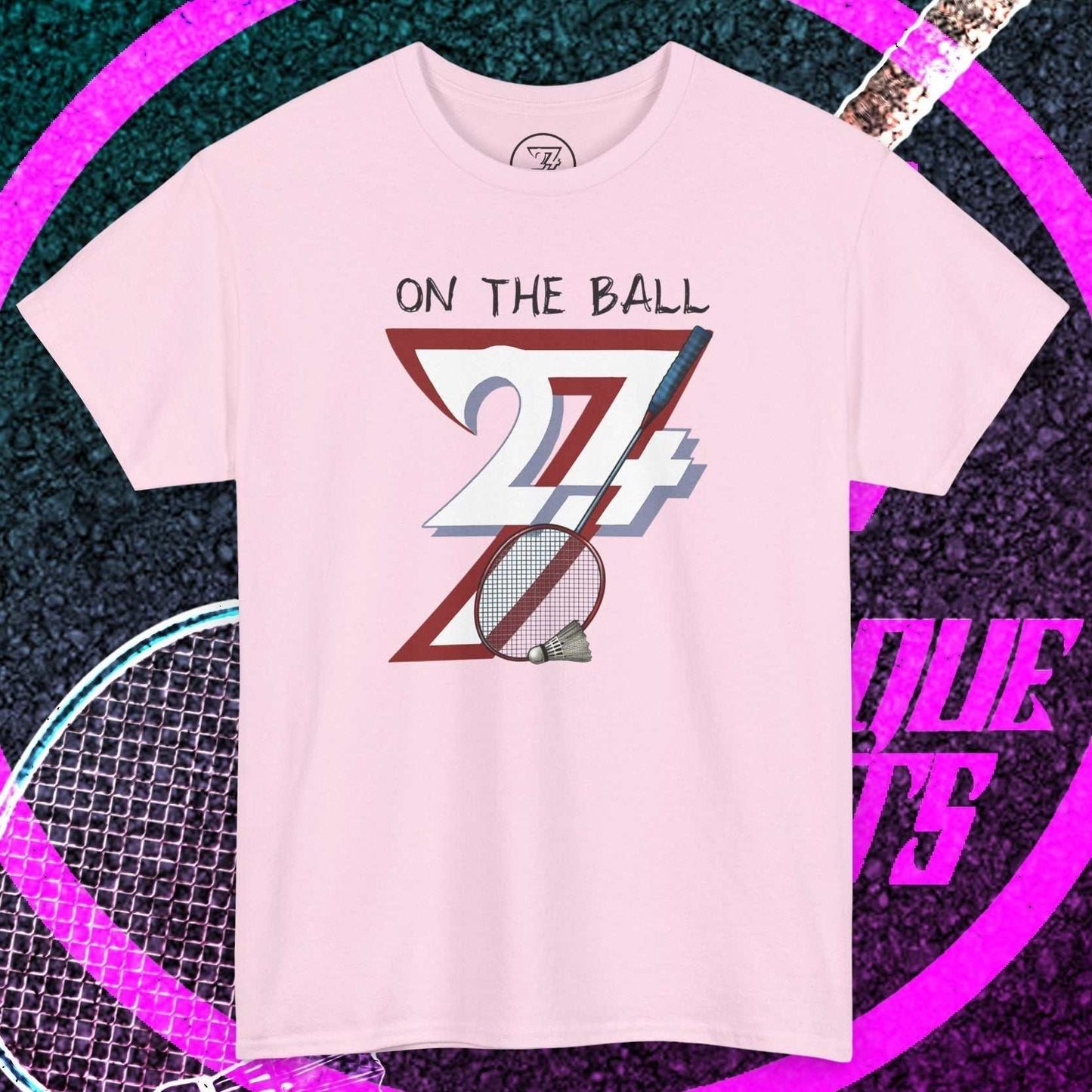 Light pink badminton tee with hand-drawn "On The Ball" graphic and shuttlecock illustration, breathable cotton sport shirt for training and casual play