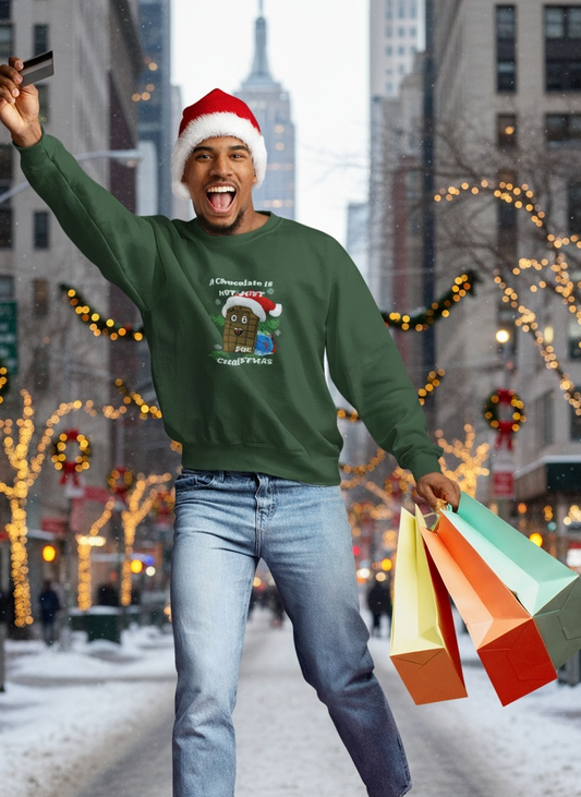 Man wearing green Christmas chocolate sweatshirt with funny cartoon character and Santa hat, holding shopping bags outdoors in winter city scene
