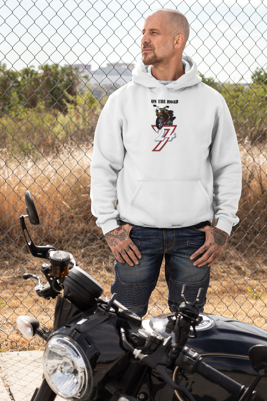 Man wearing white bike hoodie with On The Road motorcycle design standing next to black motorcycle outdoors