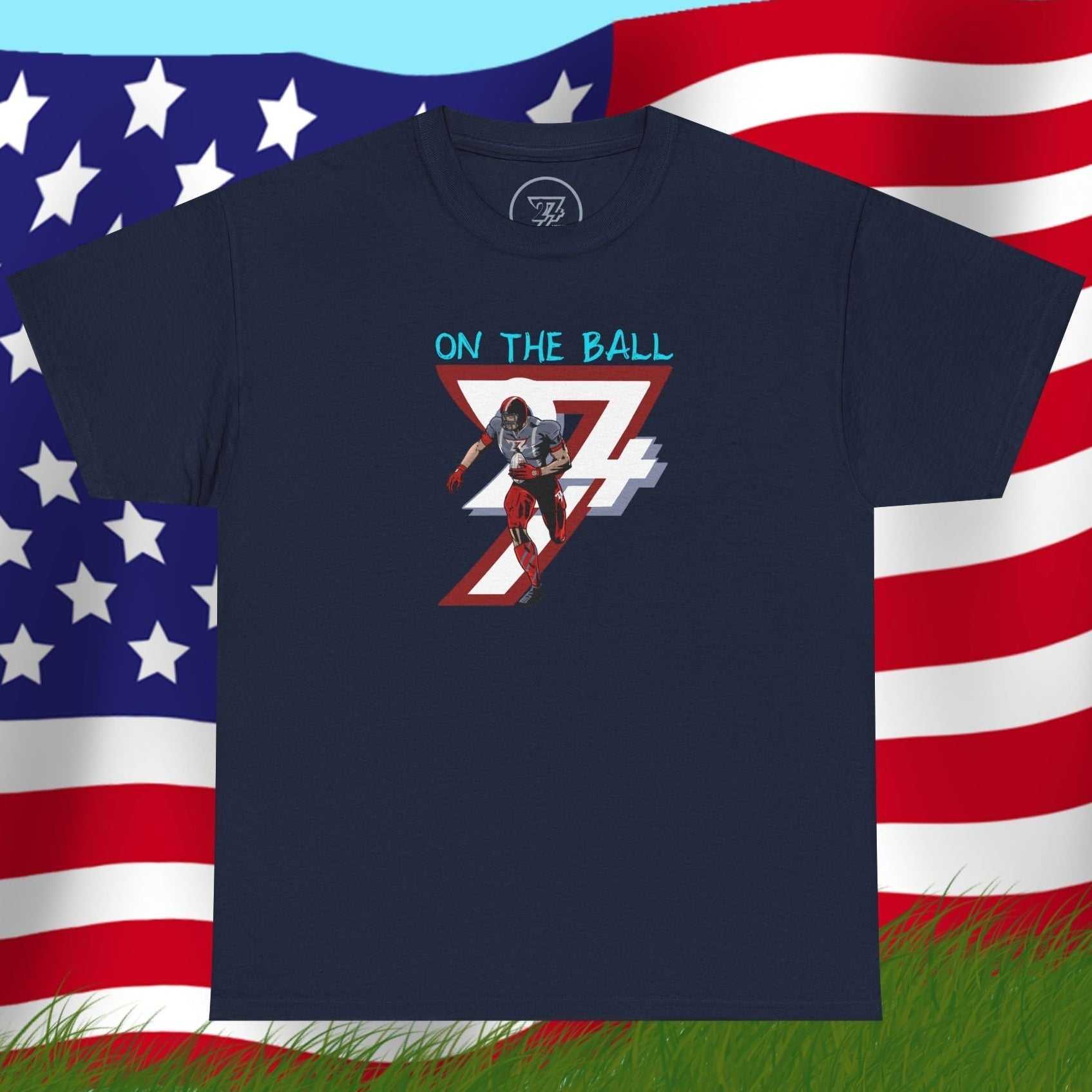 Navy American football tee with hand-drawn comic-style player graphic and "On The Ball" text, soft cotton fabric.
