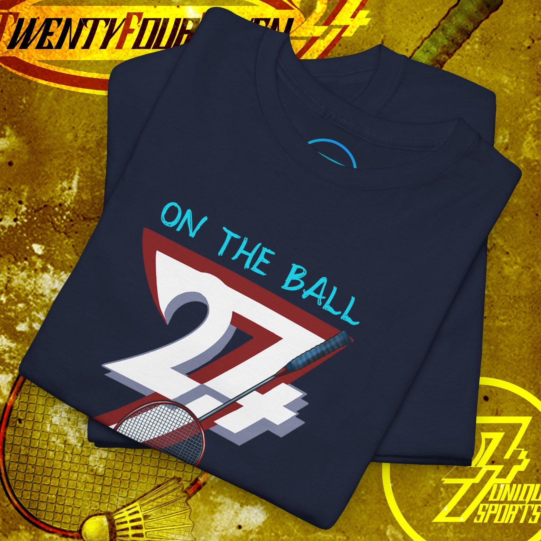 Navy badminton graphic tee with hand-drawn style "On the Ball 24/7" design, folded on textured sports background