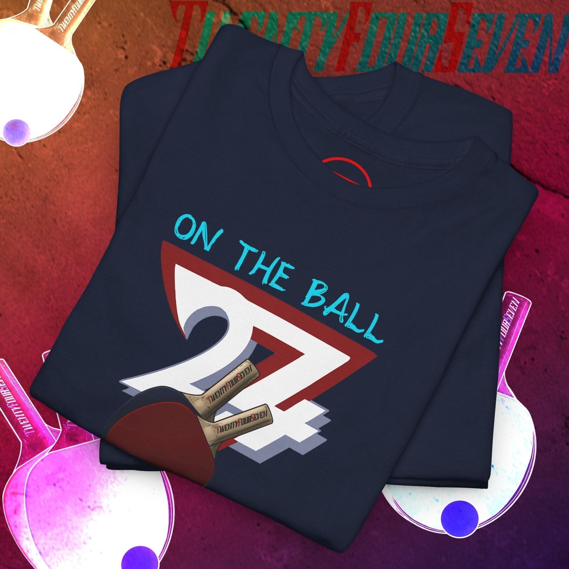 Navy blue table tennis t-shirt with hand-drawn paddle and ball graphic and "On The Ball" text, 90s style ping pong design