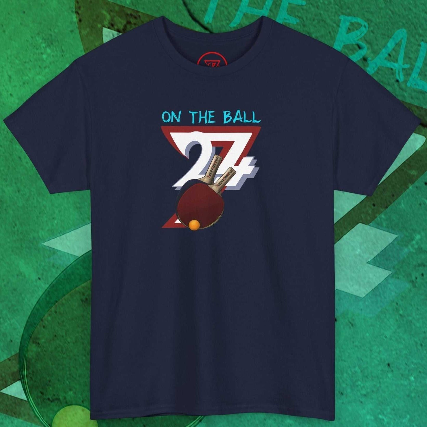Navy blue table tennis t-shirt with hand-drawn ping pong paddle and ball graphic and "On the Ball" text design