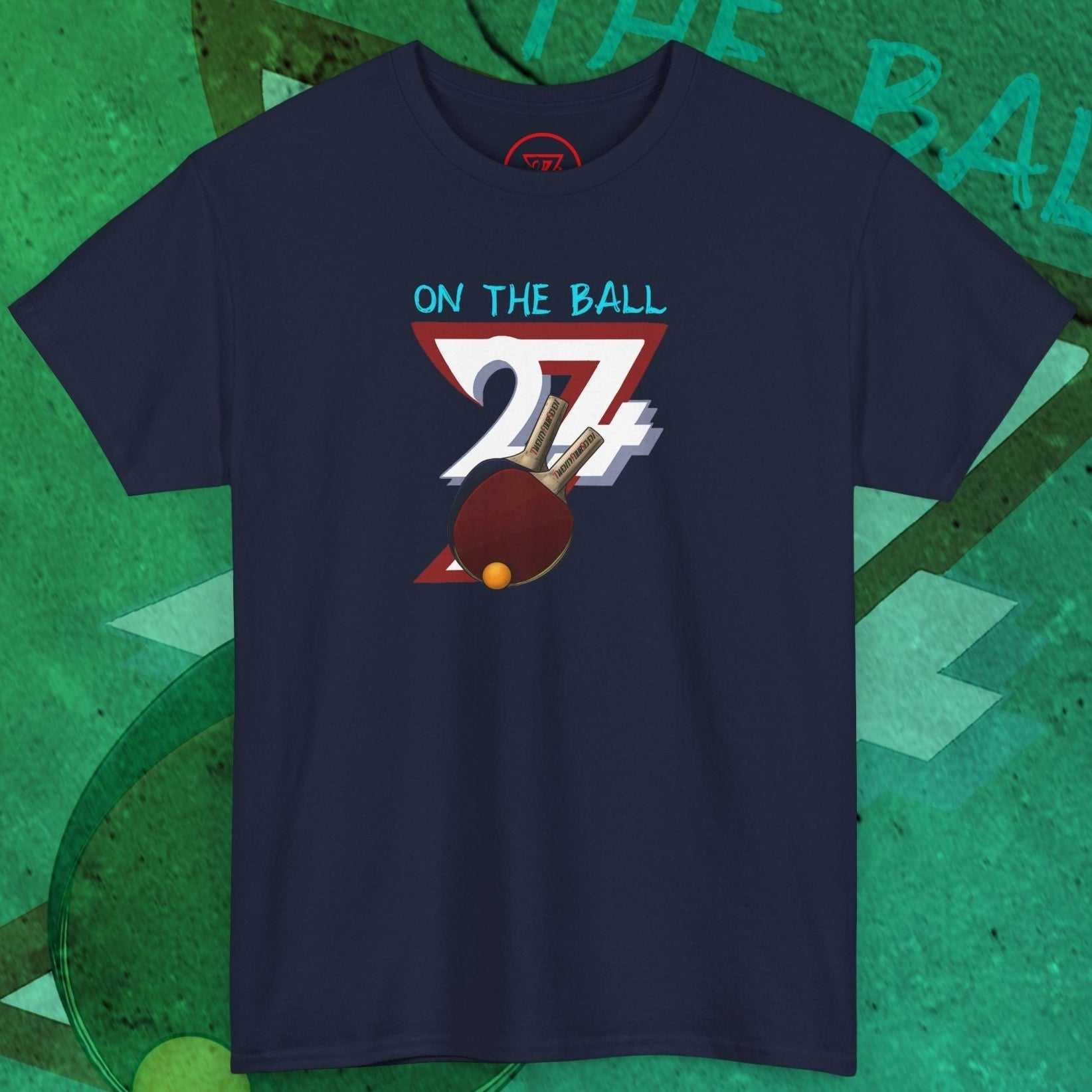 Navy blue table tennis t-shirt with hand-drawn ping pong paddle and ball graphic and "On the Ball" text design