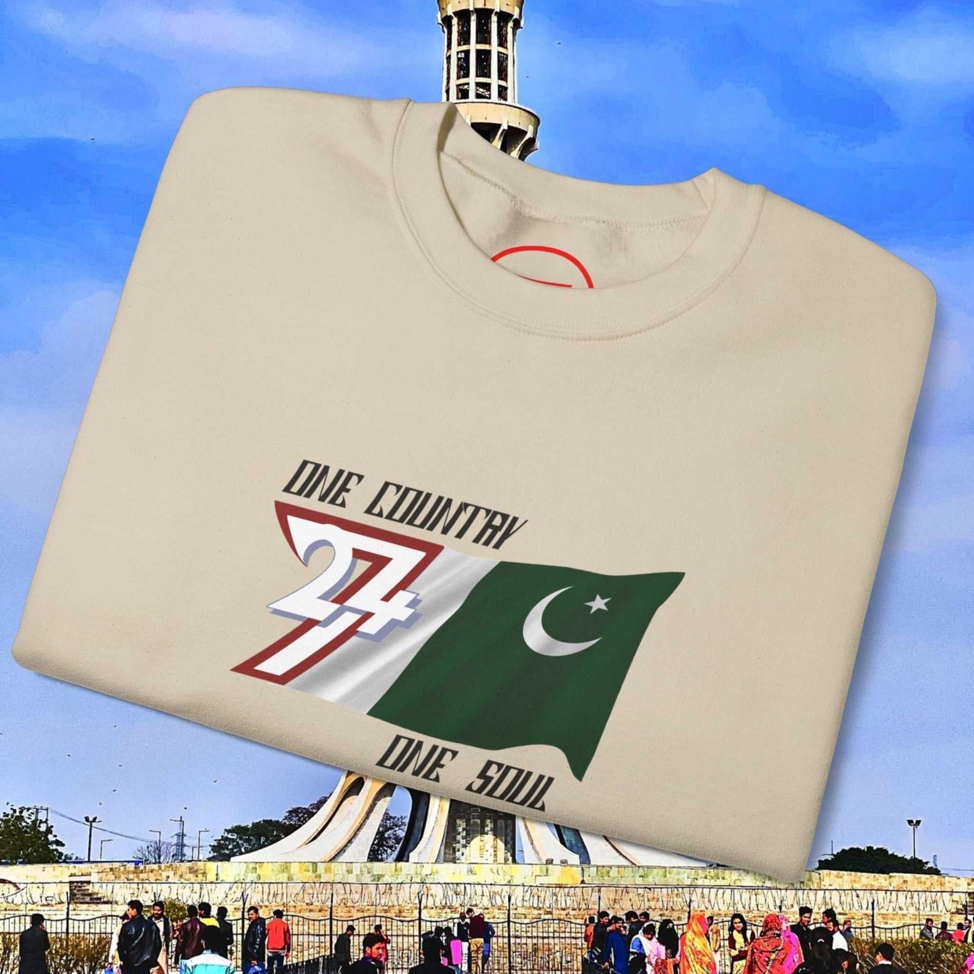 Pakistan Flag Sweatshirt with hand-drawn graphic and "One Country One Soul" slogan on cream crewneck