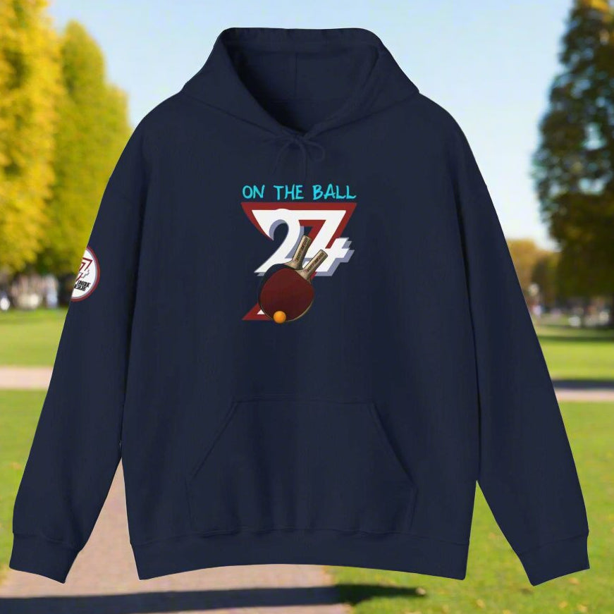 Navy ping pong hoodie with hand-drawn "On The Ball" 24/7 design and kangaroo pocket, suitable for adults.