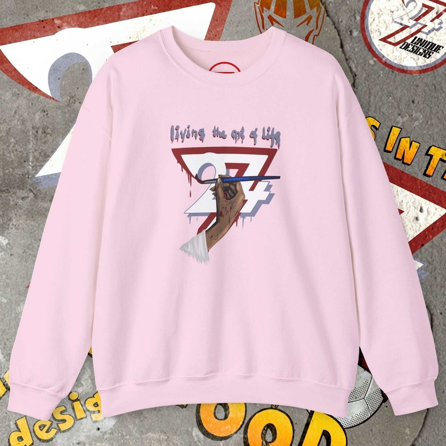 Pink artist brush sweatshirt with hand-drawn bohemian design and "living the art of life" text