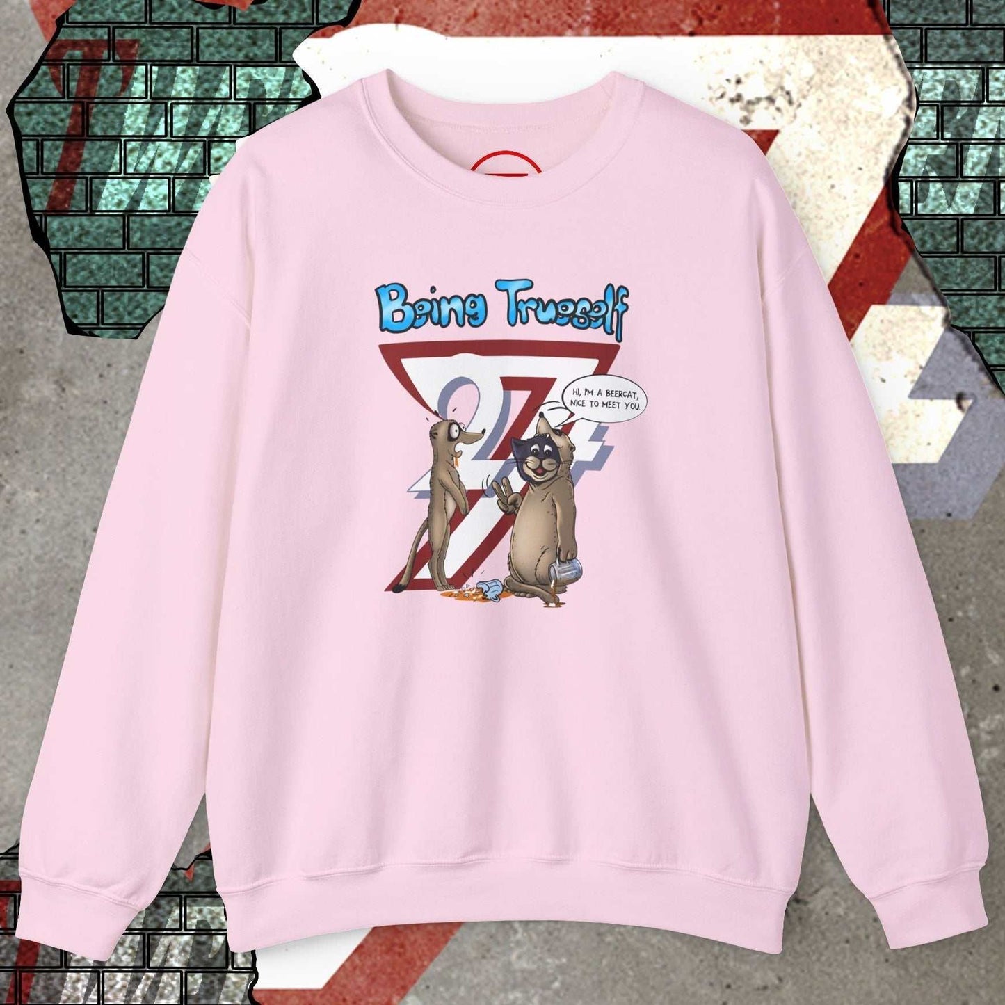 Pink unisex sweatshirt featuring cat and meerkat cartoon with "Being Trueself 24/7" slogan front design