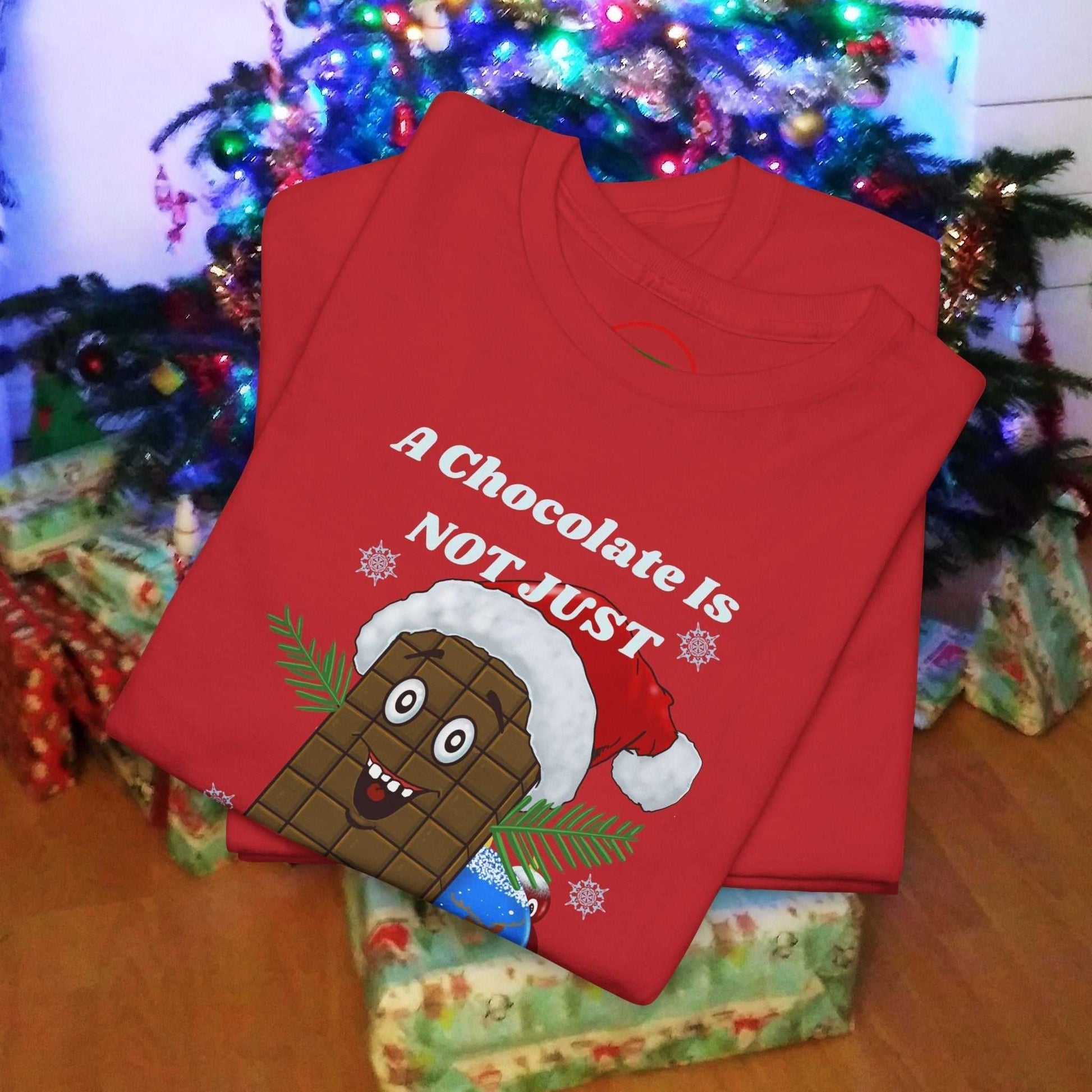 Red Christmas tee featuring a cartoon chocolate bar wearing a Santa hat with festive holiday text.