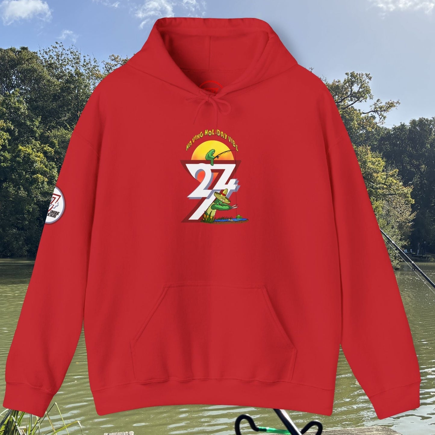 Red Funny Fishing Hoodie with cactus design and fishing theme on front and sleeve outdoors by lake