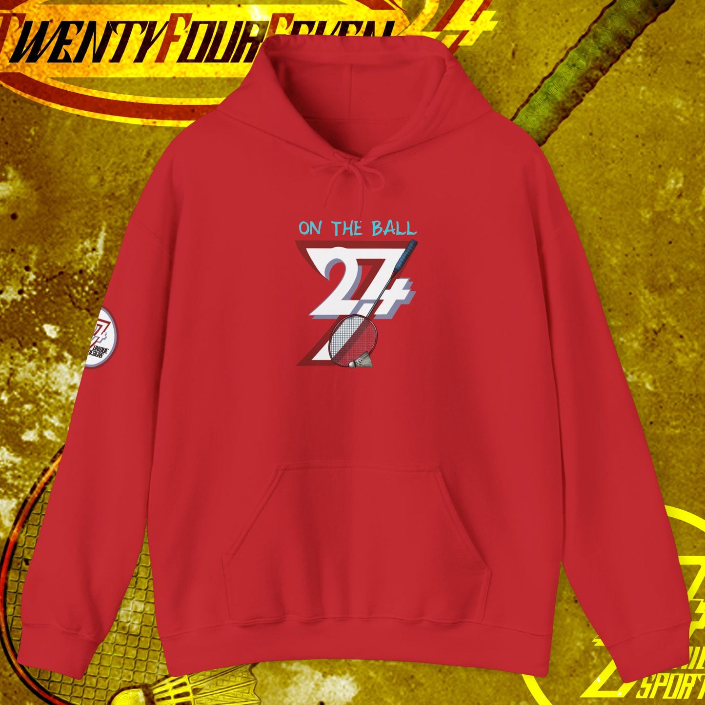 Red badminton hoodie with graphic "On the Ball 24/7" design, adjustable drawstring hood, and kangaroo pocket, ideal for outdoor sports and casual wear.
