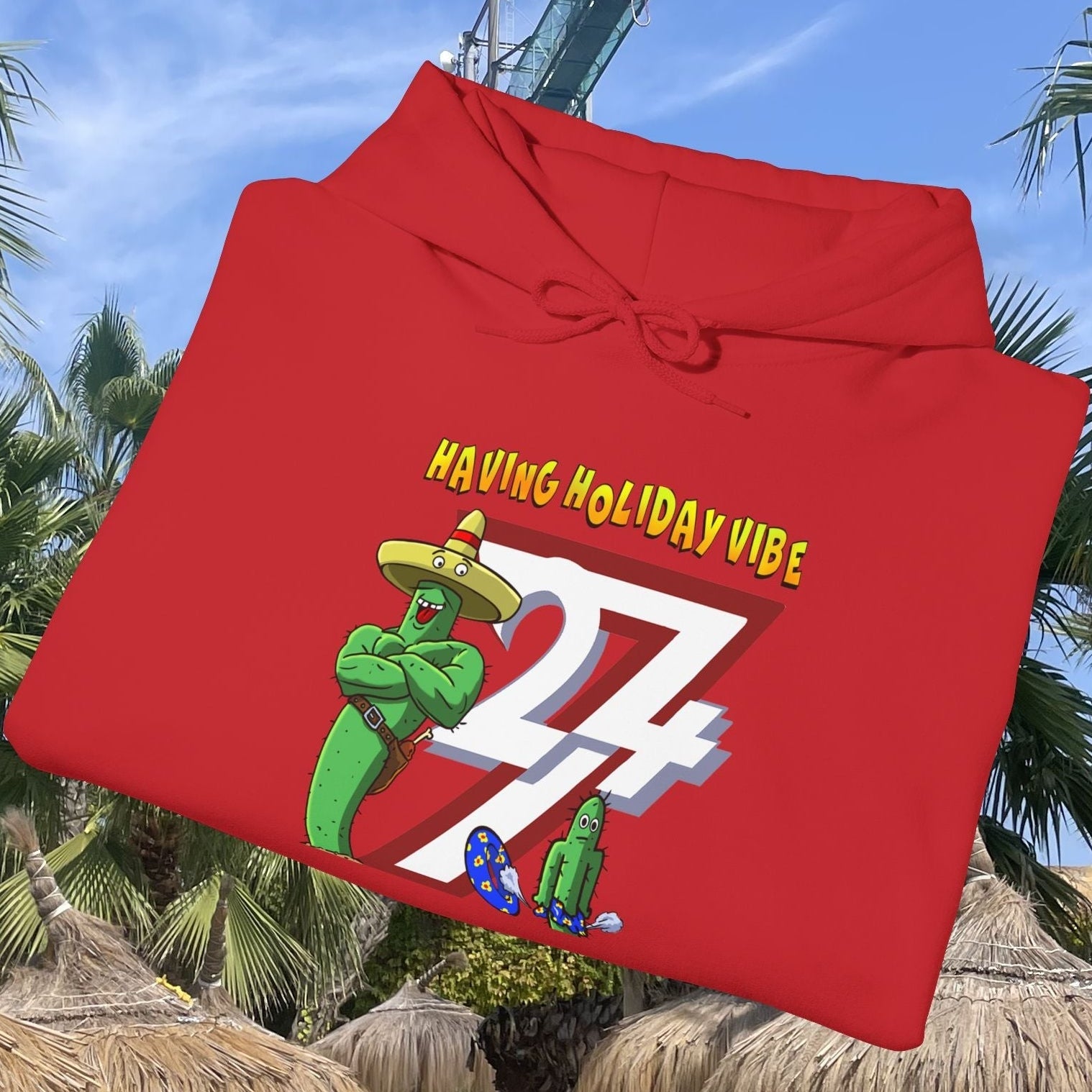 Red cactus hoodie with cartoon cactus character wearing a sombrero and "Having Holiday Vibe" text design